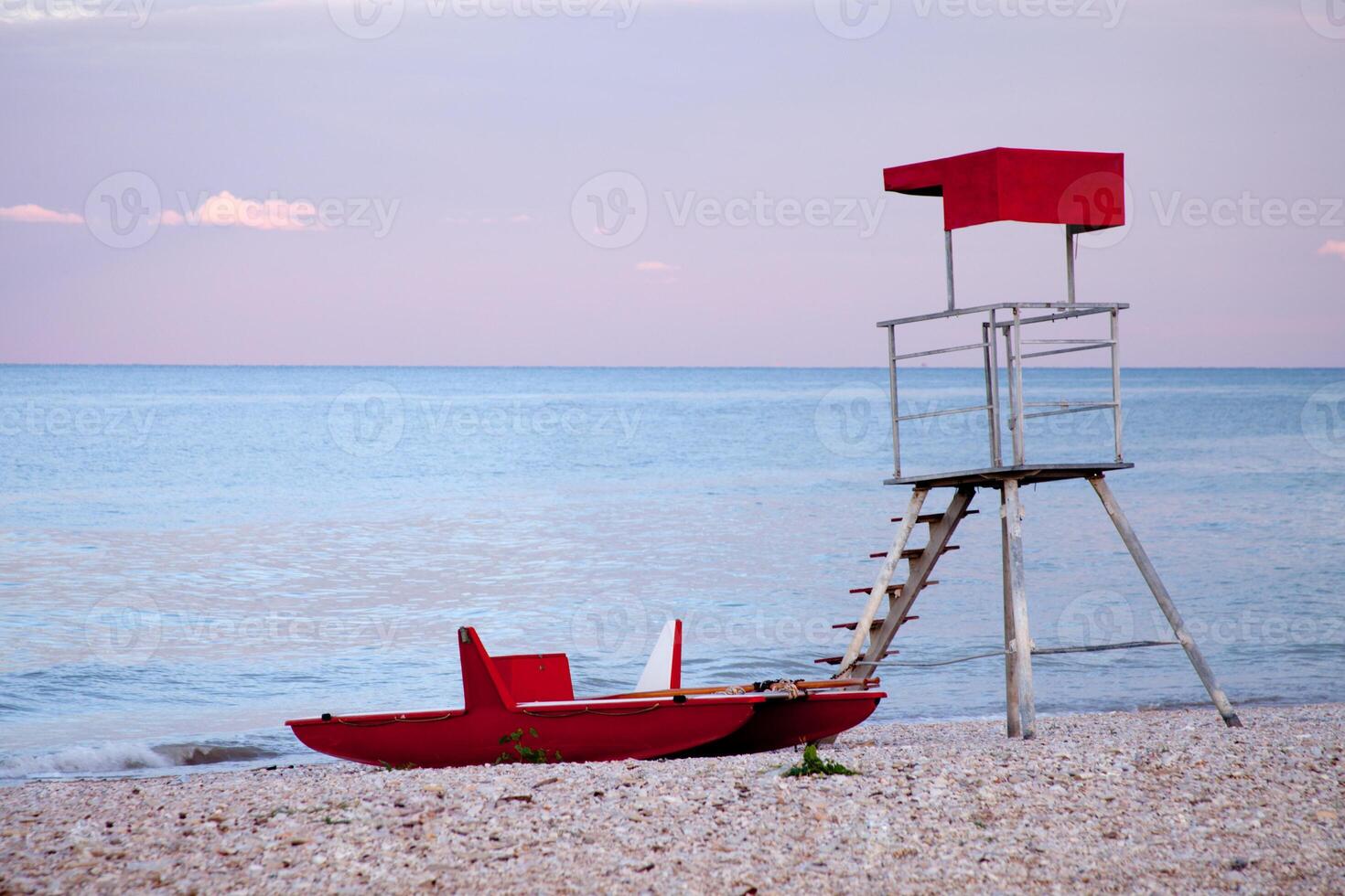 abandoned lifeguard tower and boat photo