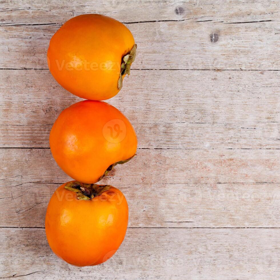 three fresh persimmons photo