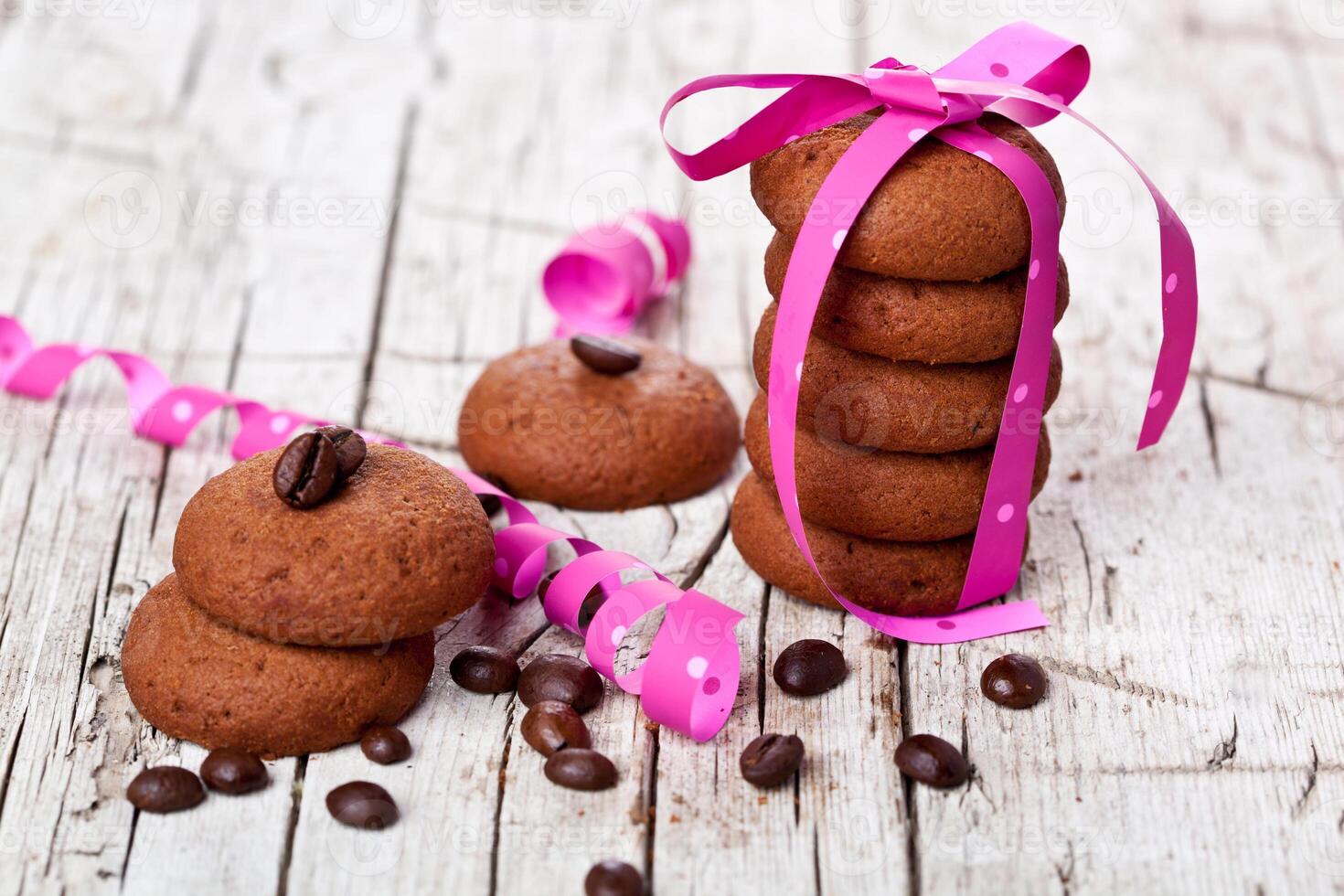 stack of chocolate cookies tied with pink ribbon and coffee beans photo