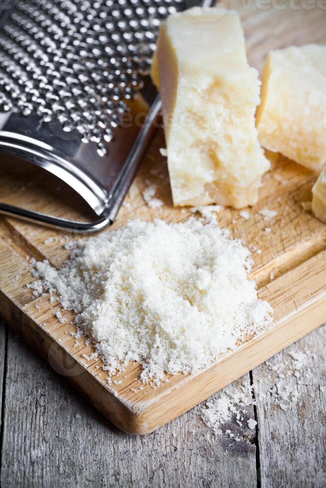 grated parmesan cheese and metal grater photo