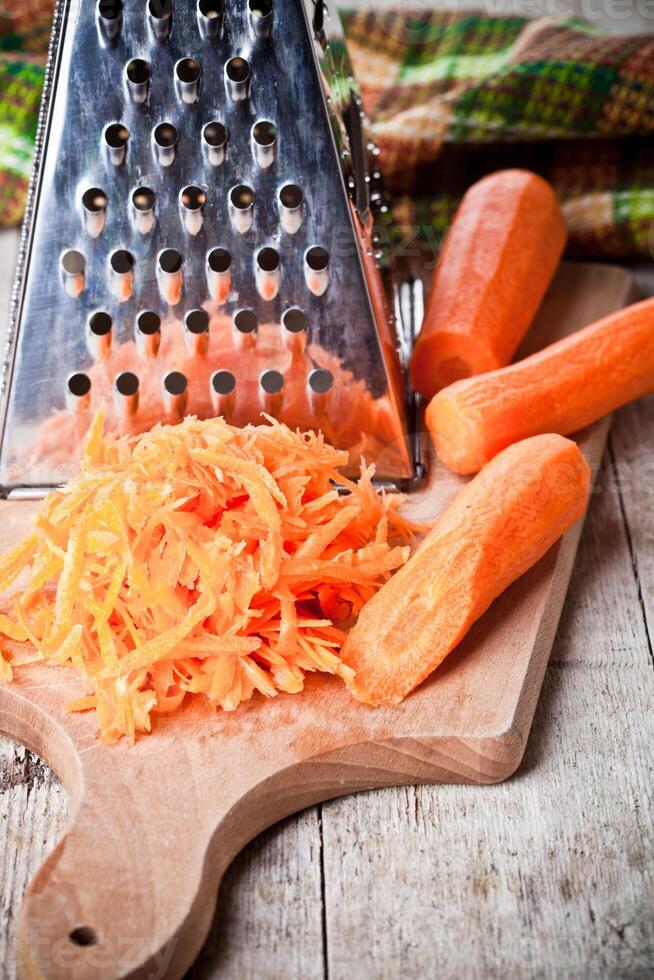 metal grater and carrots photo
