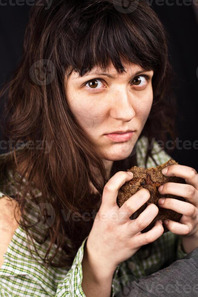 beggar woman with a piece of bread photo