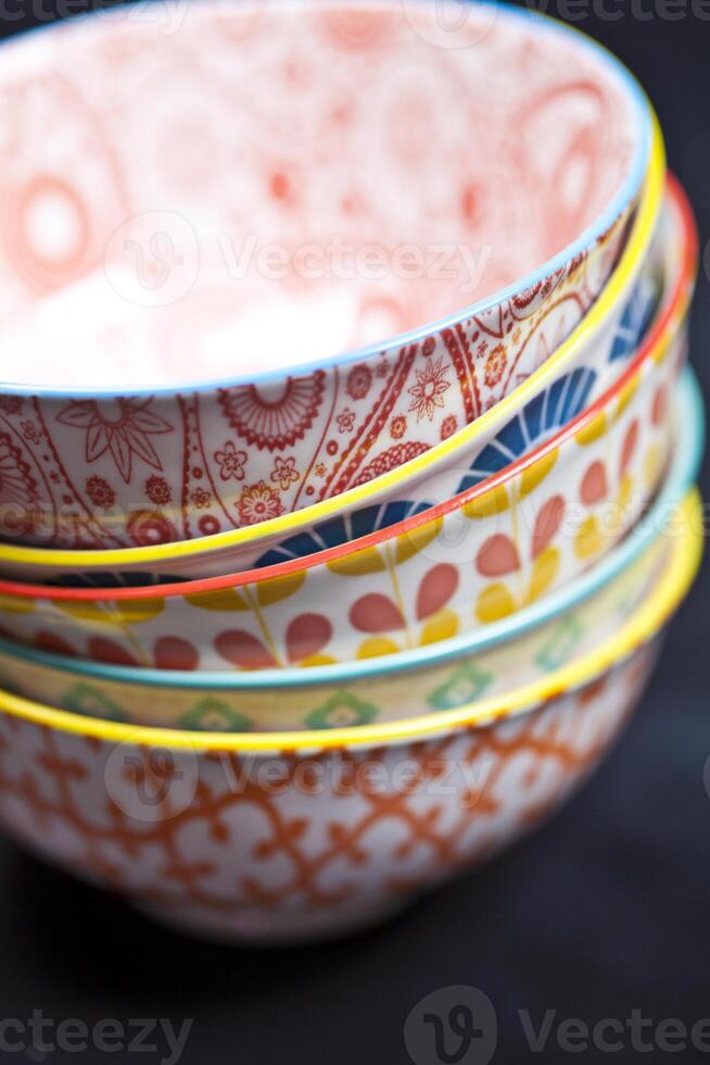 Stack of colorful empty ceramic bowls closeup. photo