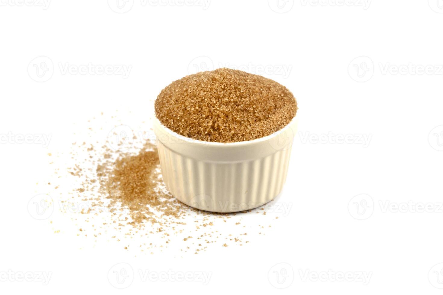 Brown cane sugar in ceramic bowl isolated on white background. photo