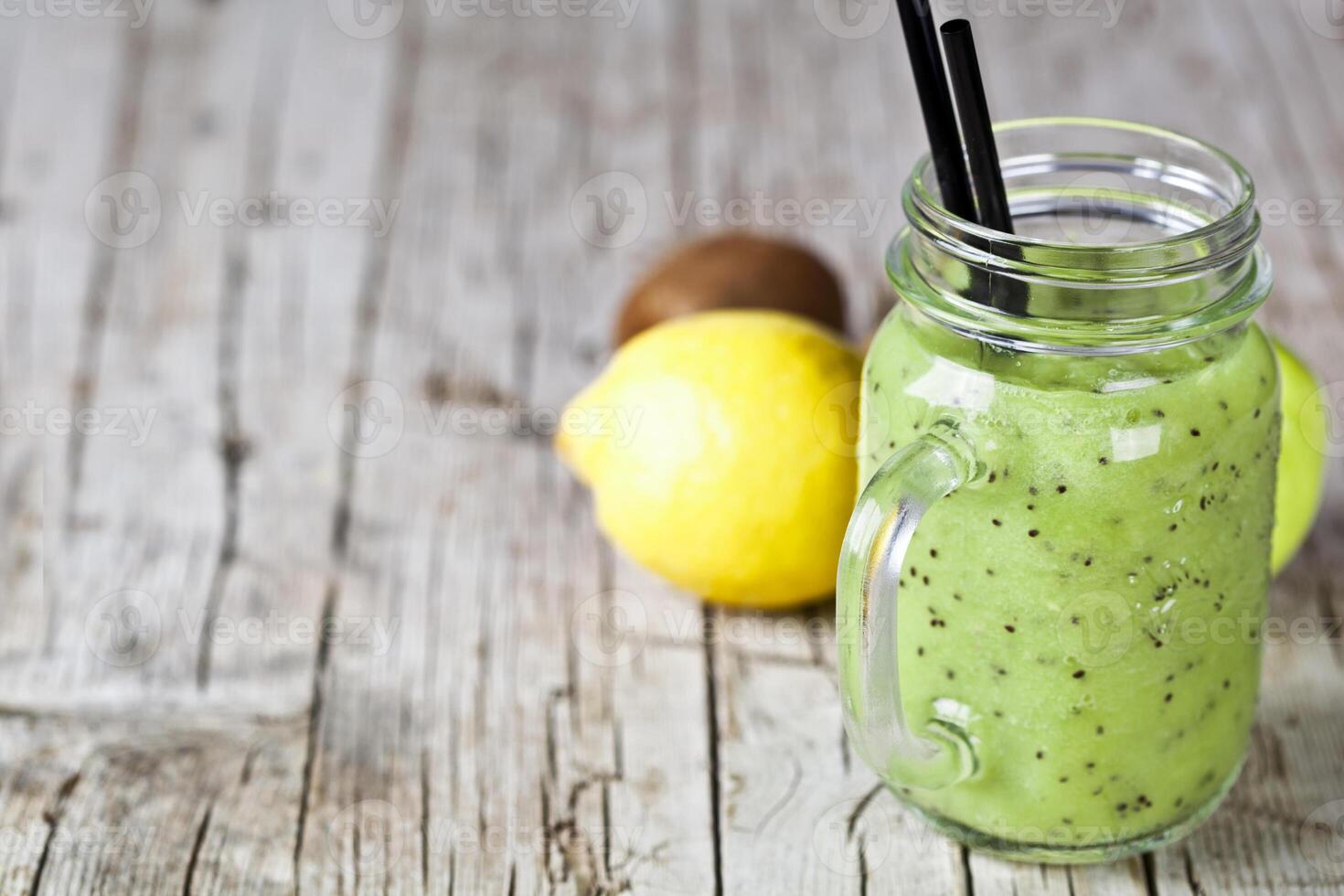 Green smoothie with kiwi, apple, lemon and chia seeds. Healthy fresh diet eating, superfood. photo