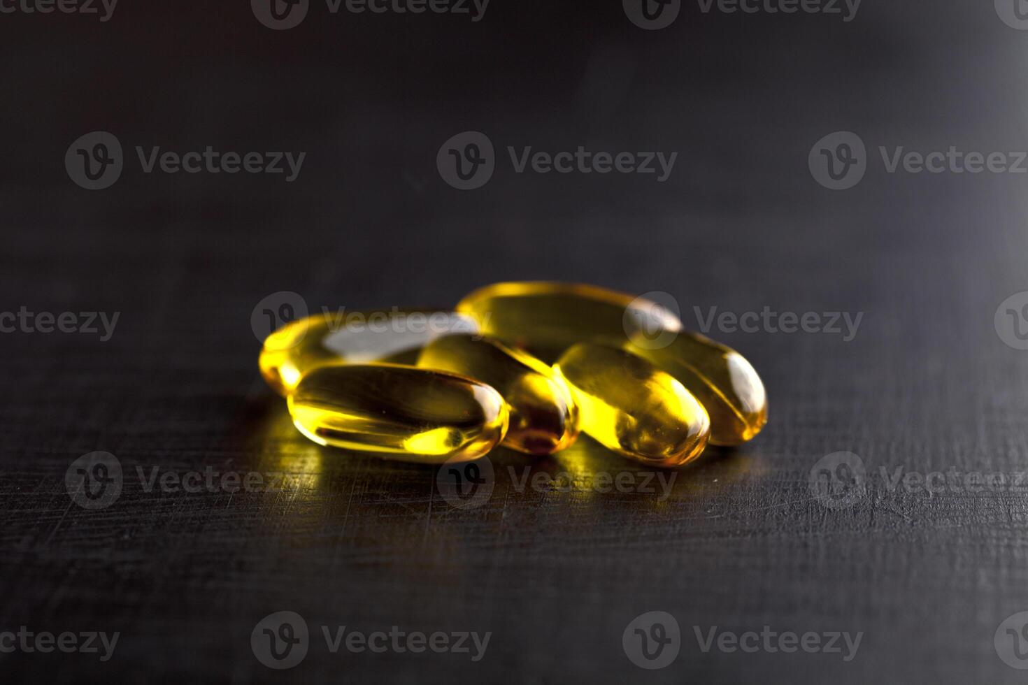 Omega-3 oil capsules and vitamin for health care on black board background. photo