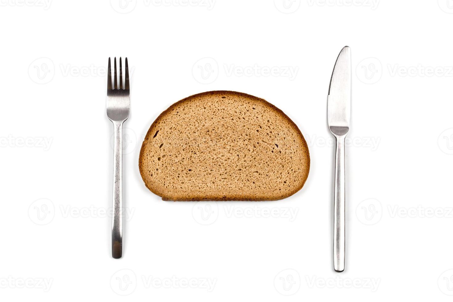 Fresh baked bread slice, fork and knife on white background. photo
