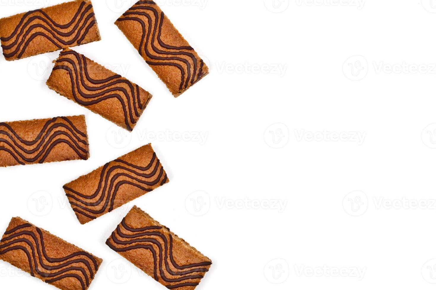 Cake bars filled with cream and decorated with dark chocolate isolated on white background. photo