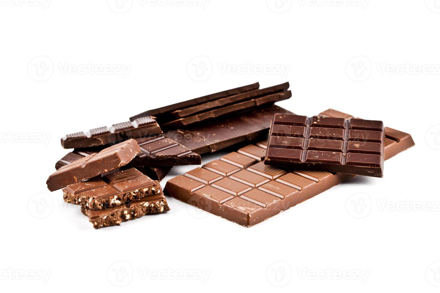 Heap of broken dark and milk chocolate bars with hazelnuts. photo