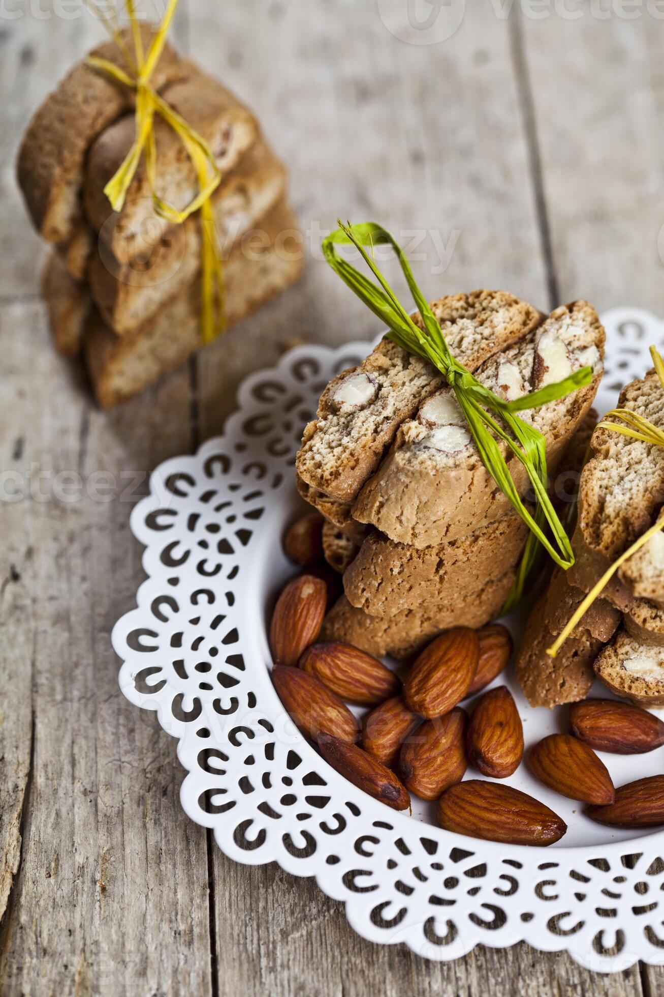 Fresh Italian cookies cantuccini stacked and almond seeds on white ...