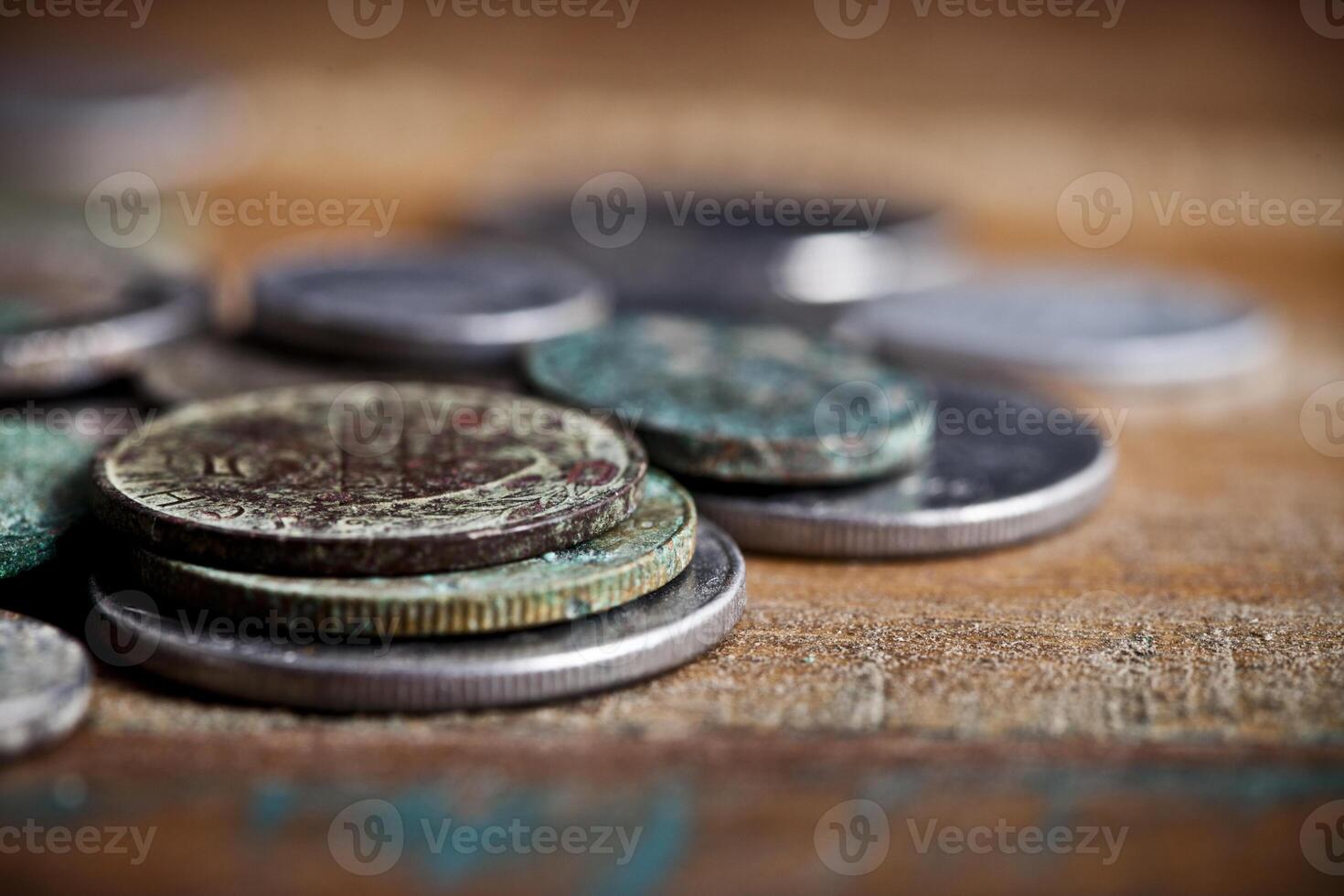 Pile of different ancient copper coins with patina. photo