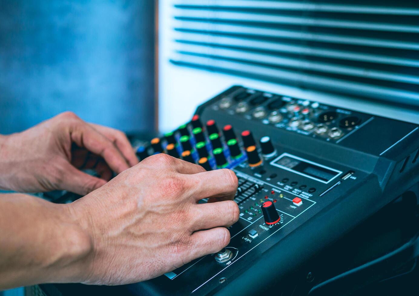 Sound engineer hands adjusting control sound mixer in recording, broadcasting studio,Sound mixer. Professional audio mixing console, buttons, faders and sliders. sound check. photo
