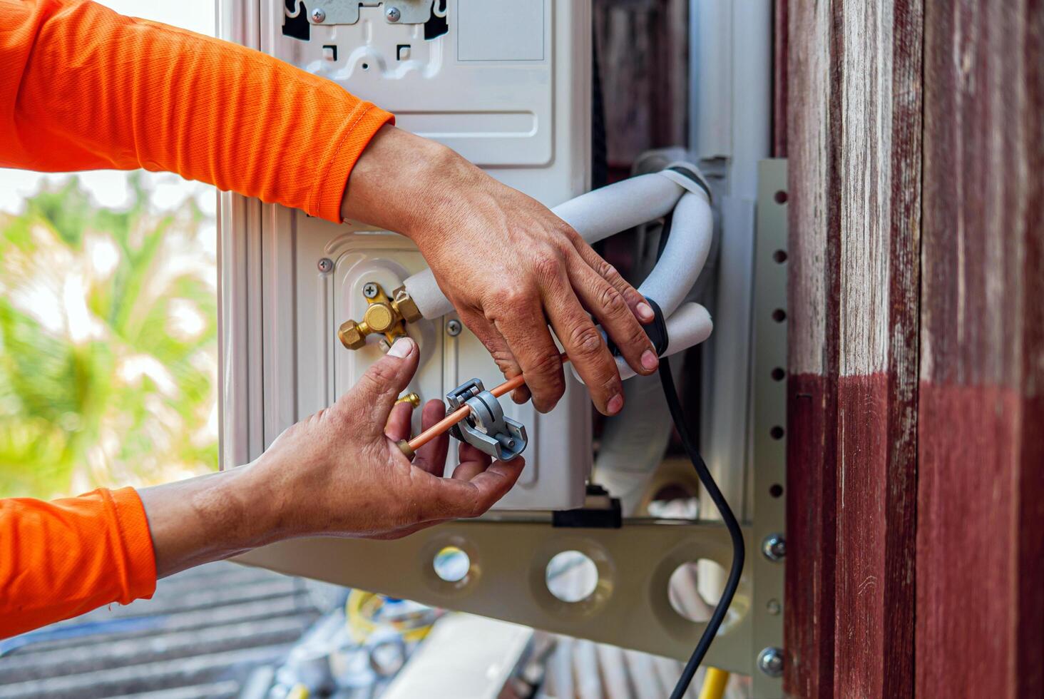 Air conditioning technicians install new compressor air in homes, Repairman fix air conditioning systems, Male technician service for repair and maintenance of air conditioners photo