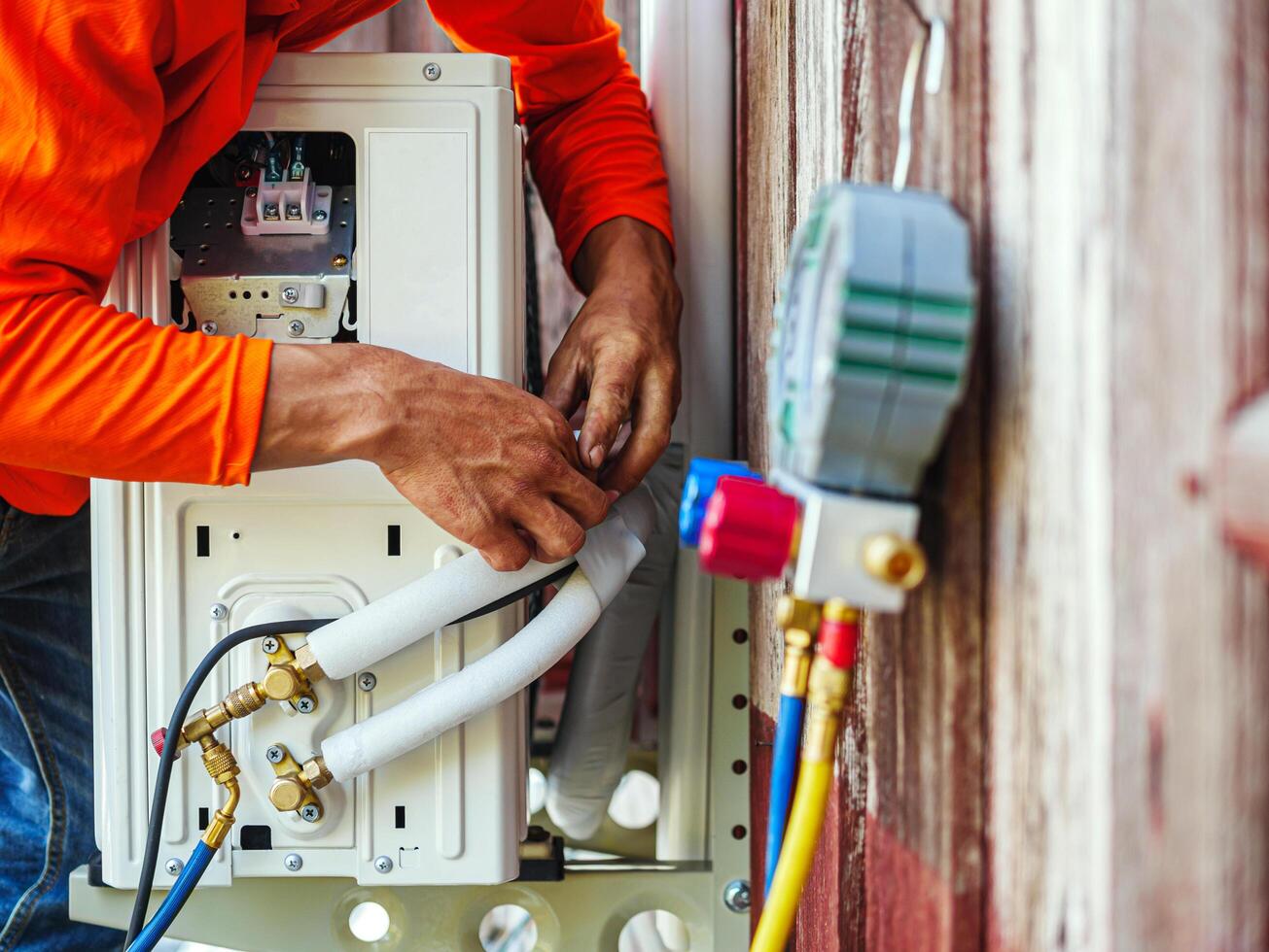 Air conditioning technicians install new compressor air in homes, Repairman fix air conditioning systems, Male technician service for repair and maintenance of air conditioners photo