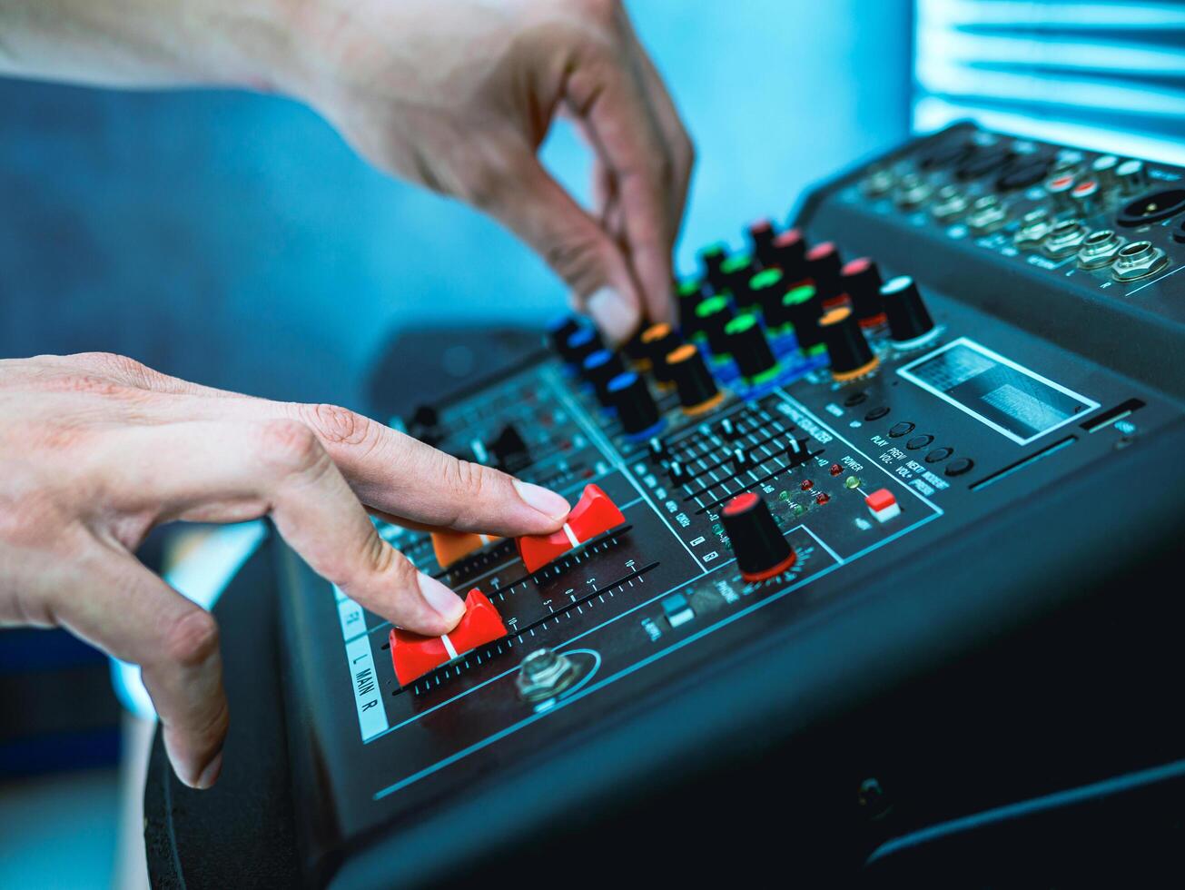 Sound engineer hands adjusting control sound mixer in recording, broadcasting studio,Sound mixer. Professional audio mixing console, buttons, faders and sliders. sound check. photo