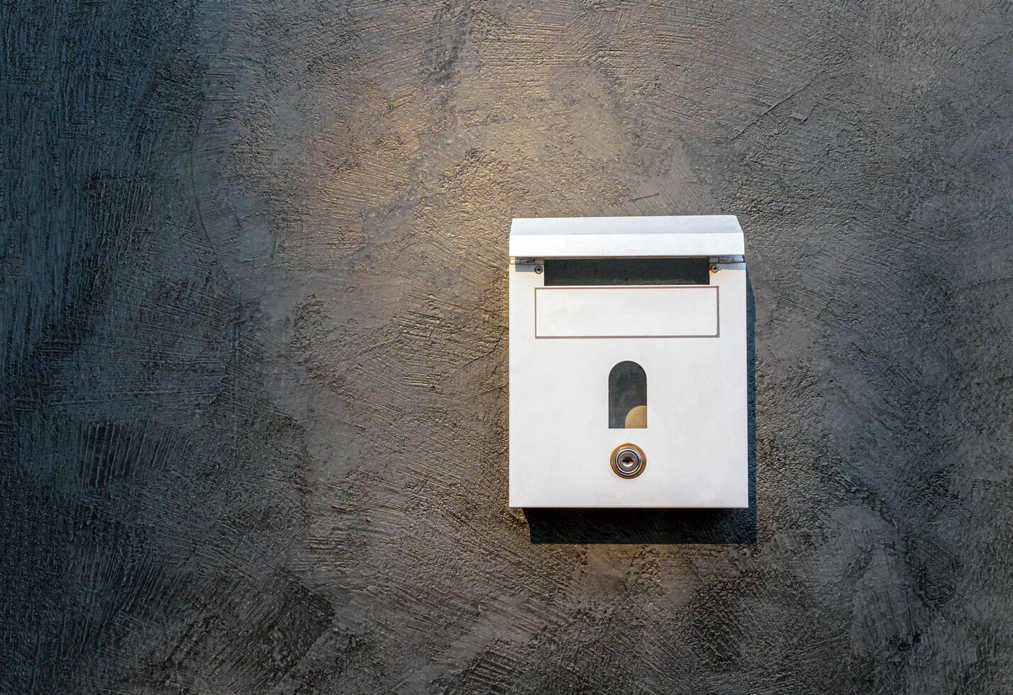 mailbox on cement background or concrete wall photo