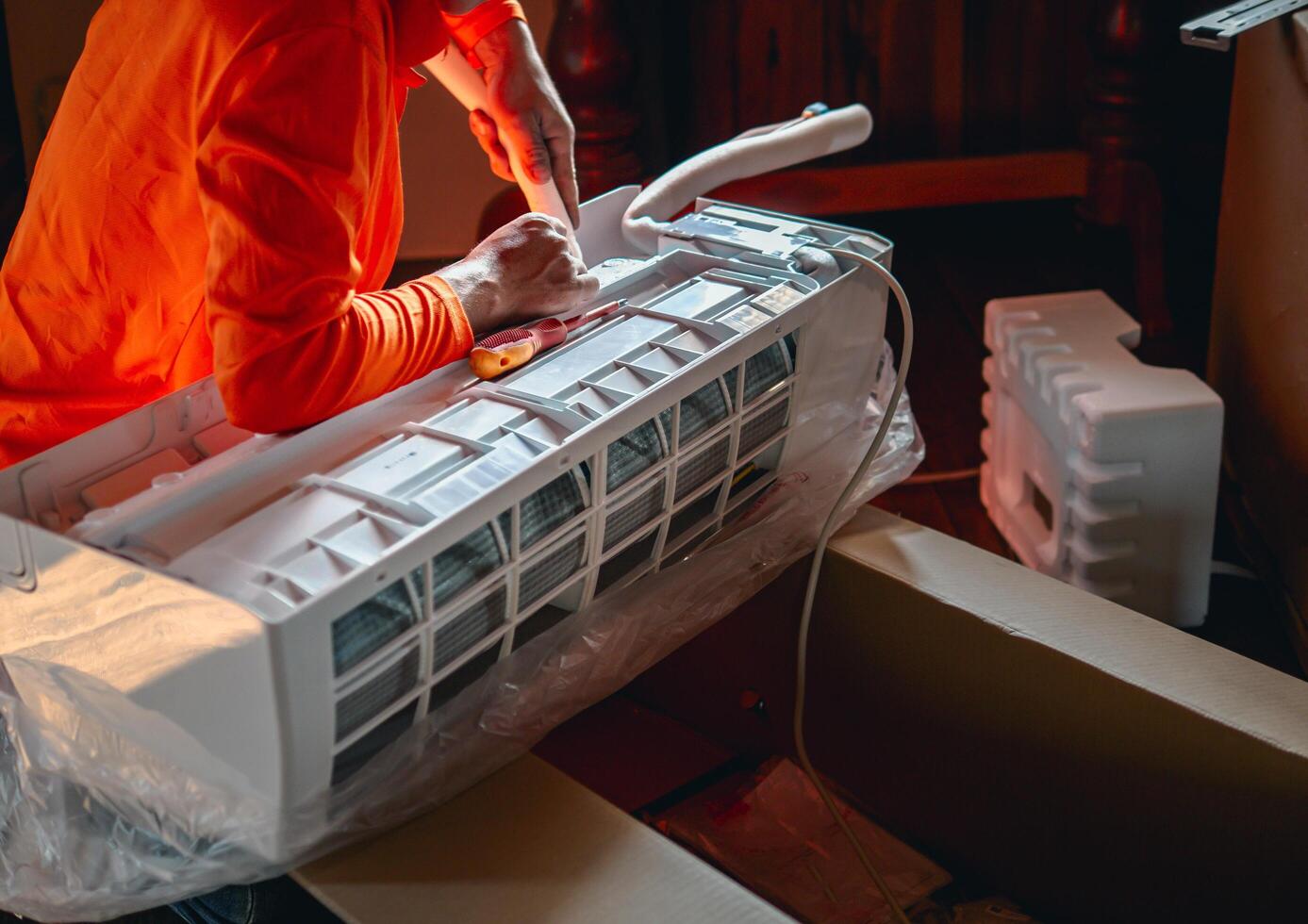 Air conditioning technicians Prepare to install new air conditioner in homes, Repairman fix air conditioning systems, Male technician service for repair and maintenance of air conditioners photo
