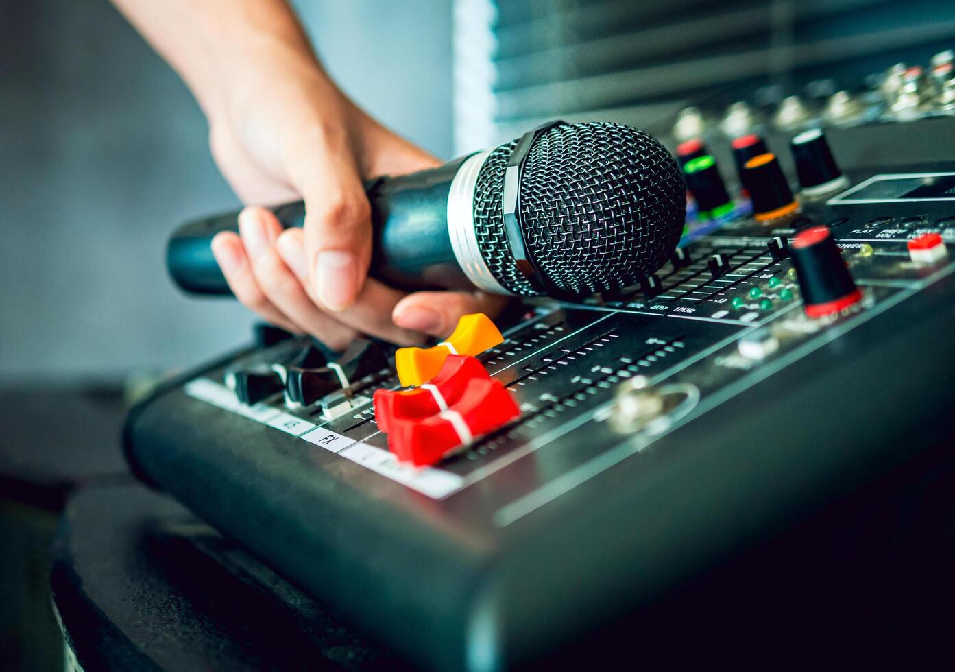 Hand Sound engineer holding microphone on sound mixer in live broadcasting studio producer for sound record control system production and audio equipment and music instrument photo