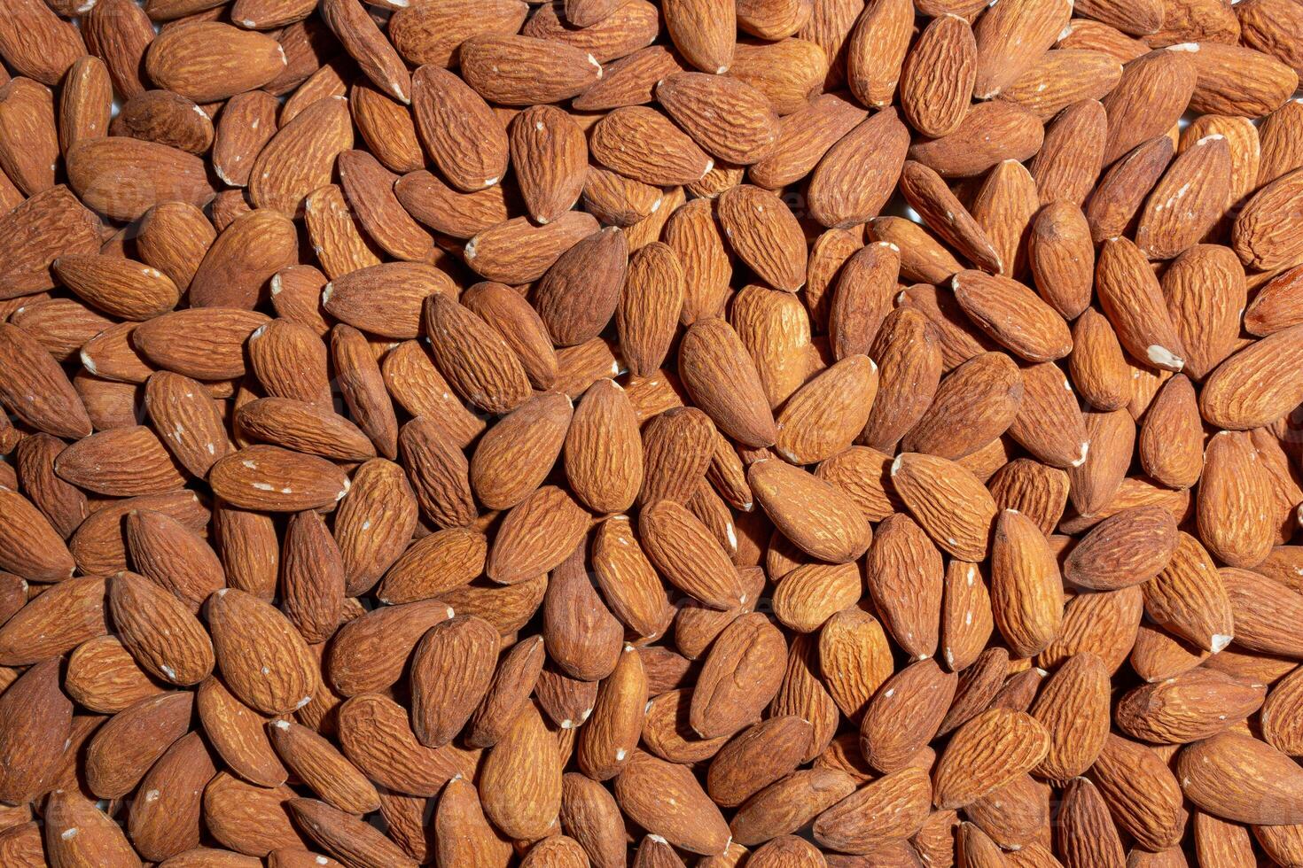 Scattered Almonds. Background from Almond Nuts. Natural High-Calorie Snacks photo