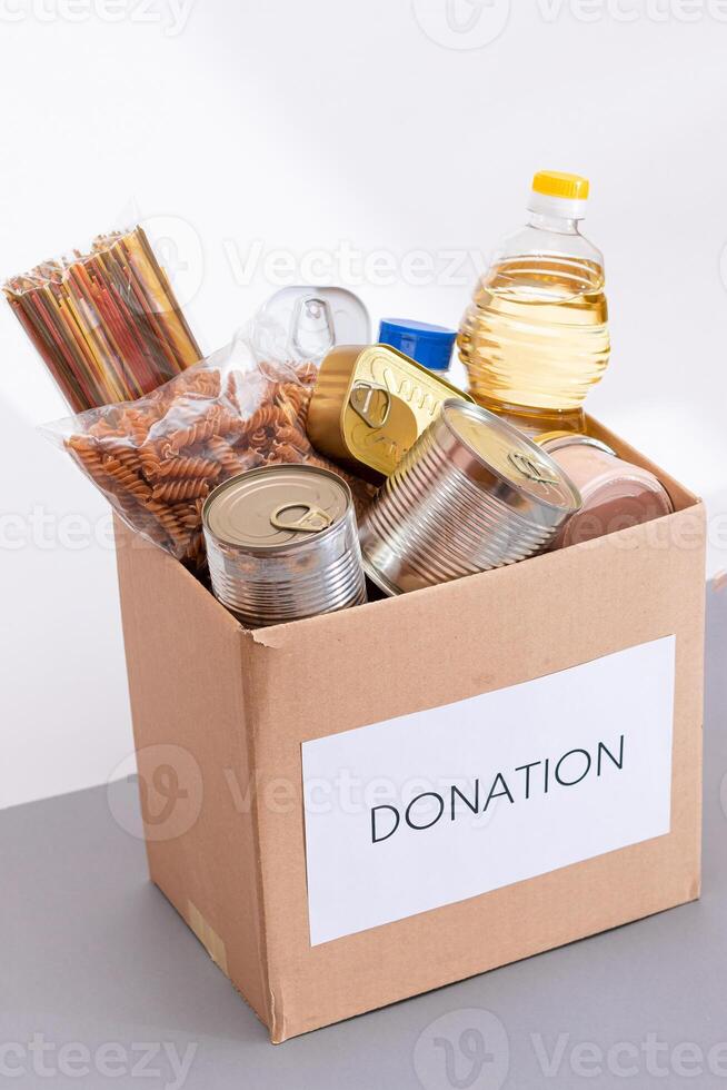 Donation Box of Free Food. Carton Box with Canned Food, Cereals and Grocery. Meal Reserves. Emergency Food Storage in Case of Crisis. Free Social Help, Blessings and Care. Strategic Food Supplies photo