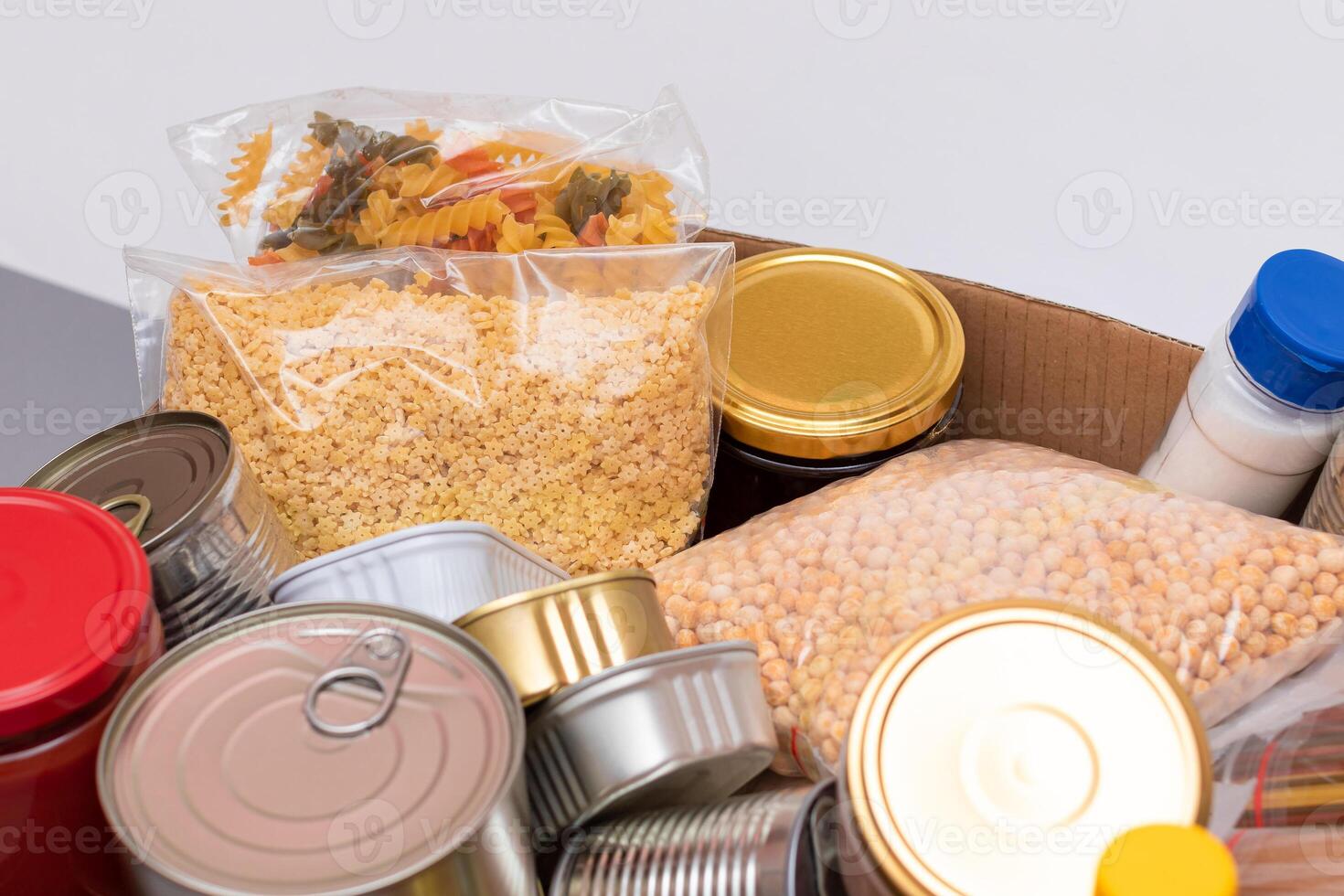Donation Box of Free Food. Carton Box with Canned Food, Cereals and Grocery. Meal Reserves. Emergency Food Storage in Case of Crisis. Free Social Help, Blessings and Care. Strategic Food Supplies photo