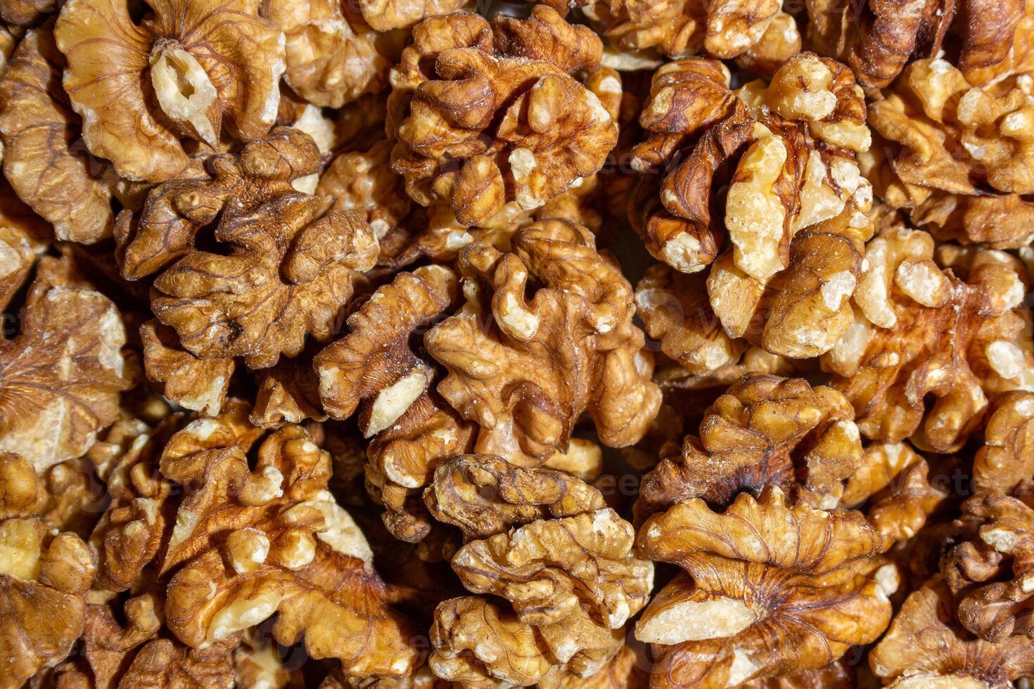 Scattered Shelled Walnuts. Background from Walnut. Natural High-Calorie Snacks photo