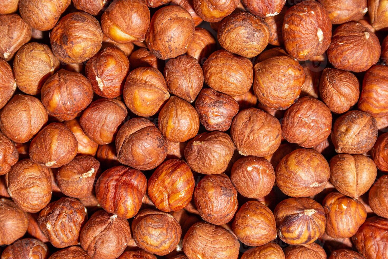 Scattered Peeled Hazelnut - Top View. Background from Hazelnuts. Natural High-Calorie Snacks photo