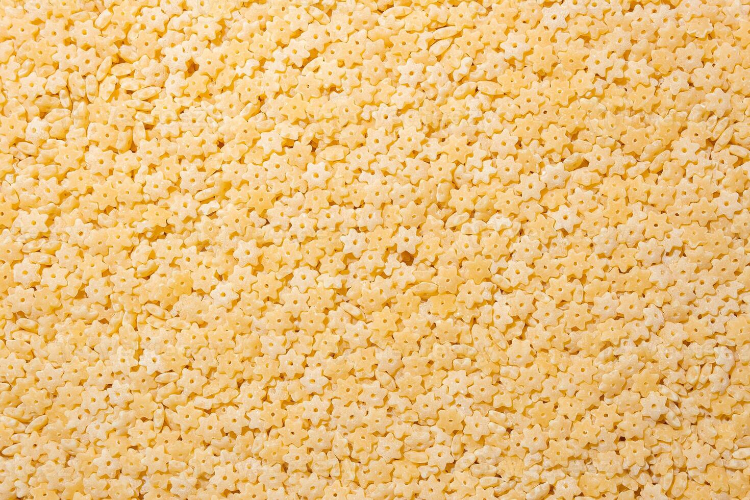 Uncooked Stelline Pasta. A Culinary Canvas of Stelline Macaroni, Creating a Lively and Textured Background for Gourmet Cooking. Dry Pasta. Raw Macaroni - Top View, Flat Lay photo