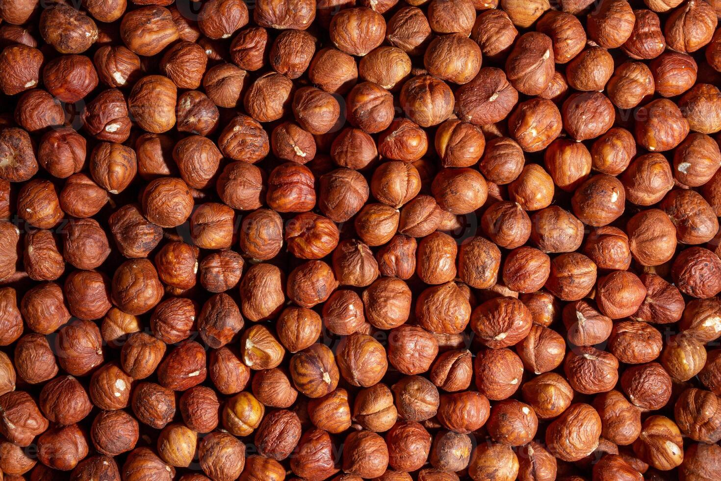 Scattered Peeled Hazelnut - Top View. Background from Hazelnuts. Natural High-Calorie Snacks photo