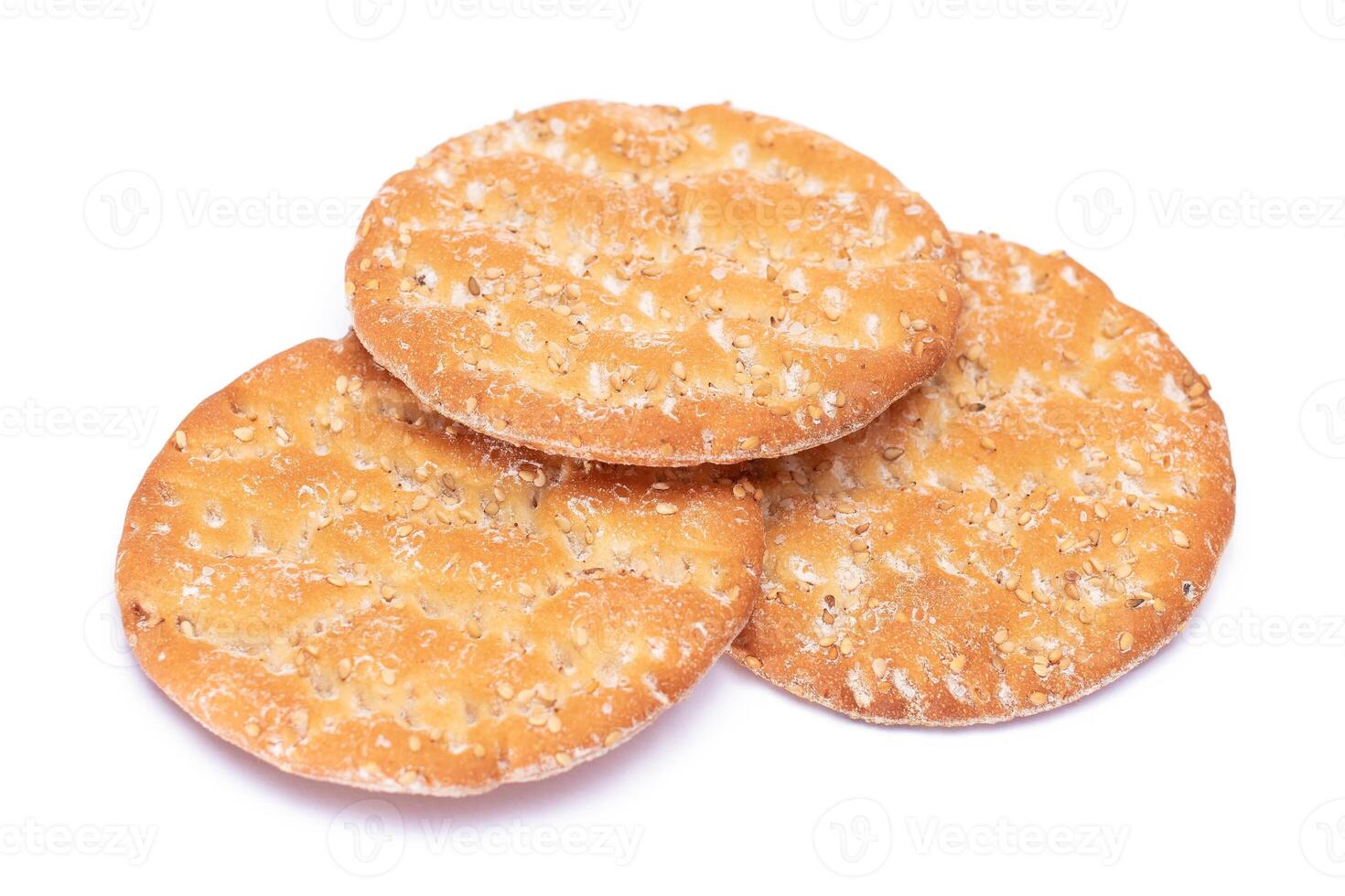 A Heap of Round Salt Crackers with Sesame Isolated on White Background. Dry Snacks - Isolation photo
