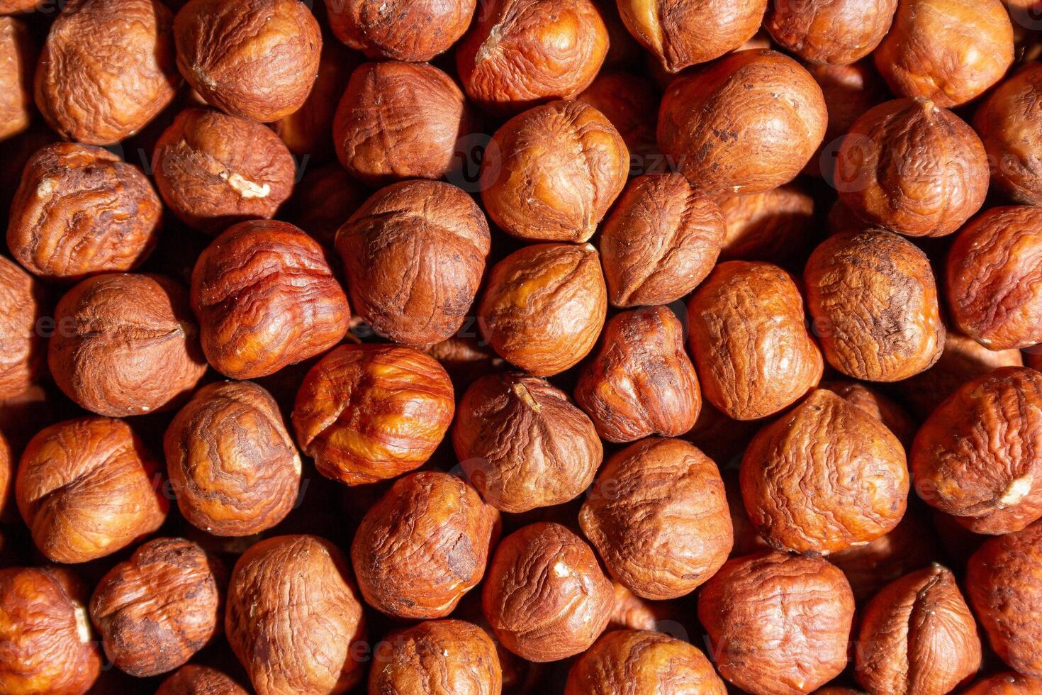 Scattered Peeled Hazelnut - Top View. Background from Hazelnuts. Natural High-Calorie Snacks photo