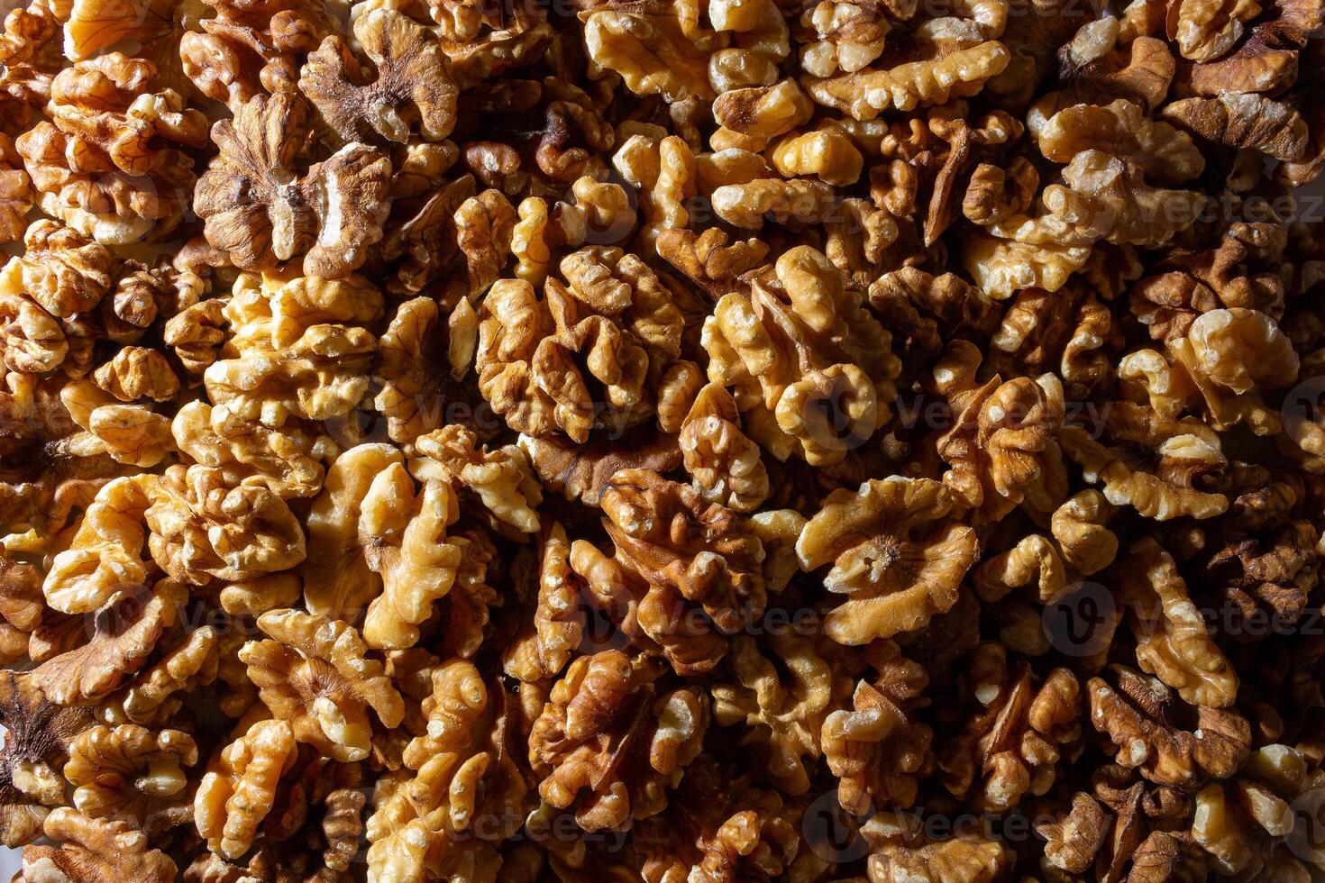 Scattered Shelled Walnuts. Background from Walnut. Natural High-Calorie Snacks photo
