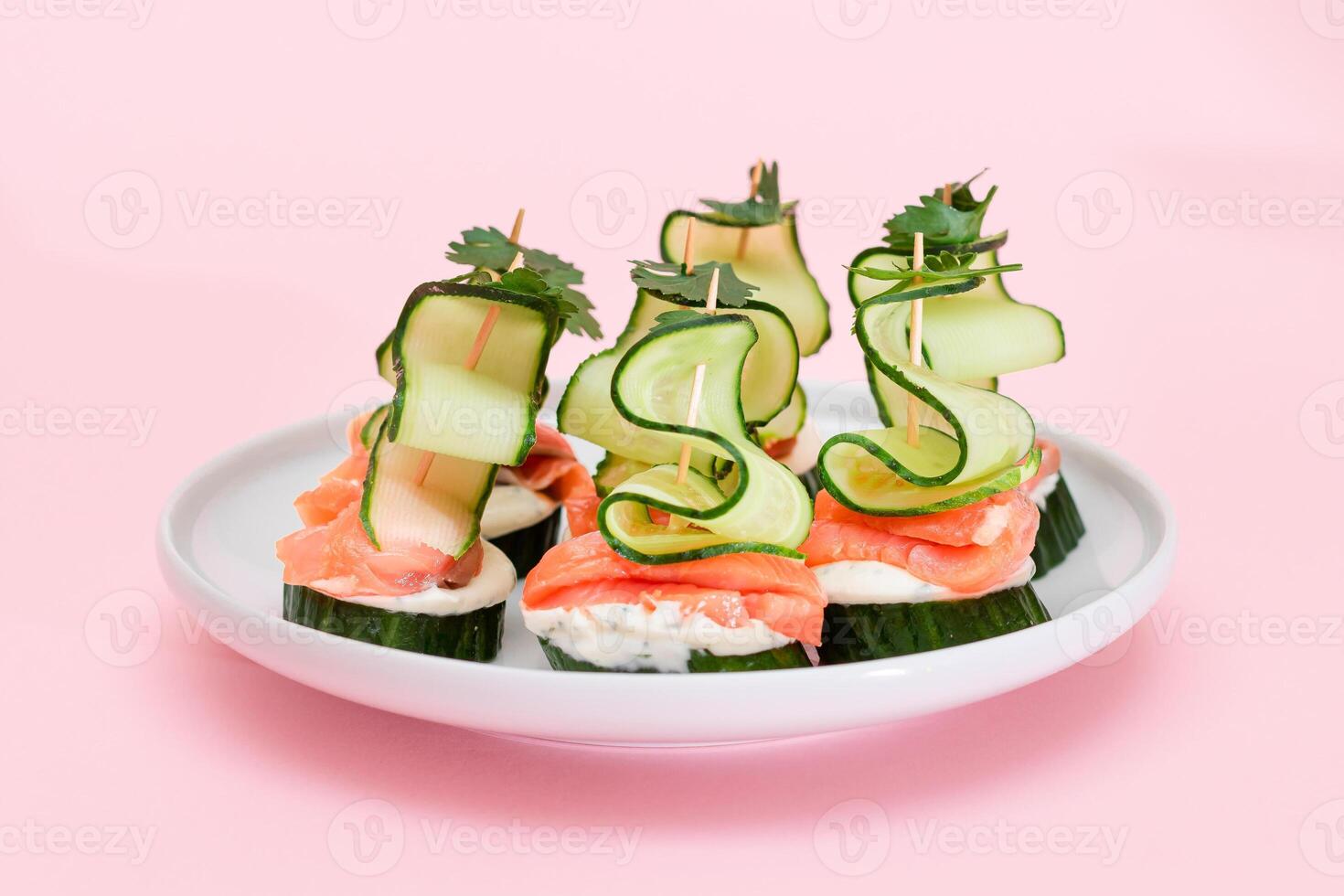 Canapes without Bread with Fresh Salmon, Cucumber and Cream Cheese on White Plate. Easy Breakfast. Diet Food. Quick and Healthy Sandwiches. Healthy Snacks with Tasty Fillings photo