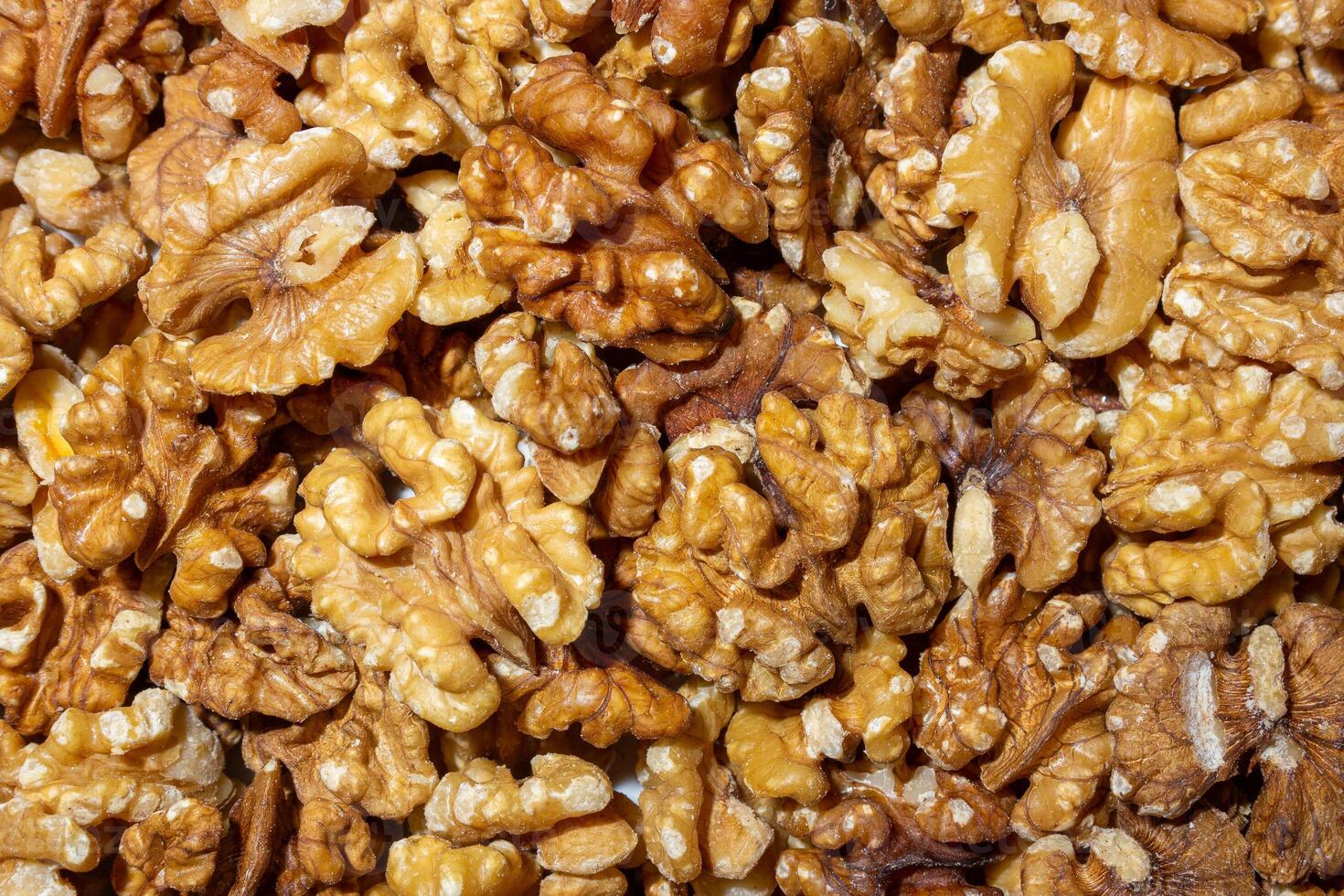 Scattered Shelled Walnuts. Background from Walnut. Natural High-Calorie Snacks photo