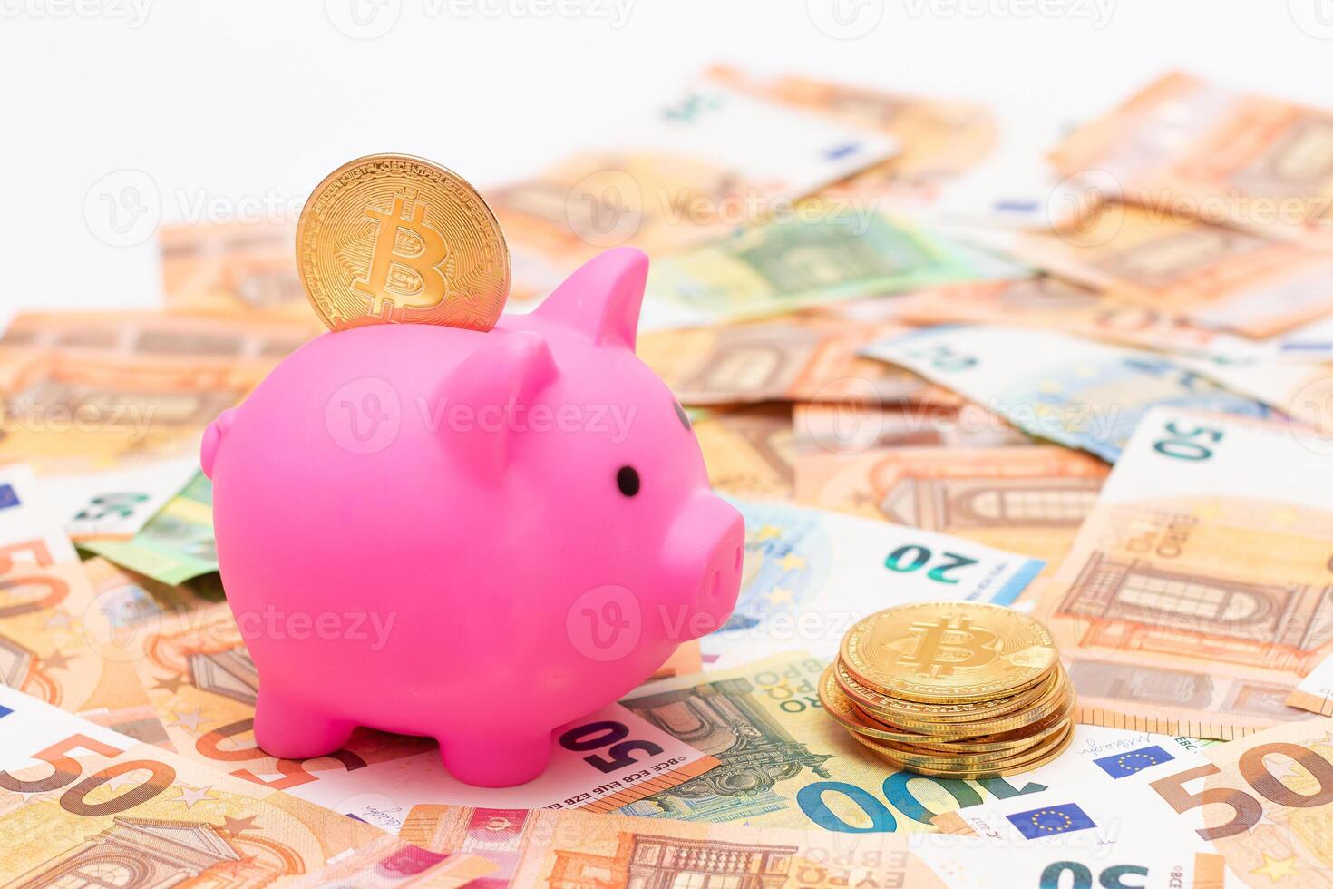 Pink Piggy Bank with Bitcoin Coin on the Fifty Euro Banknotes. Small Money Box for Cash and Coins. Money Saving Concept photo