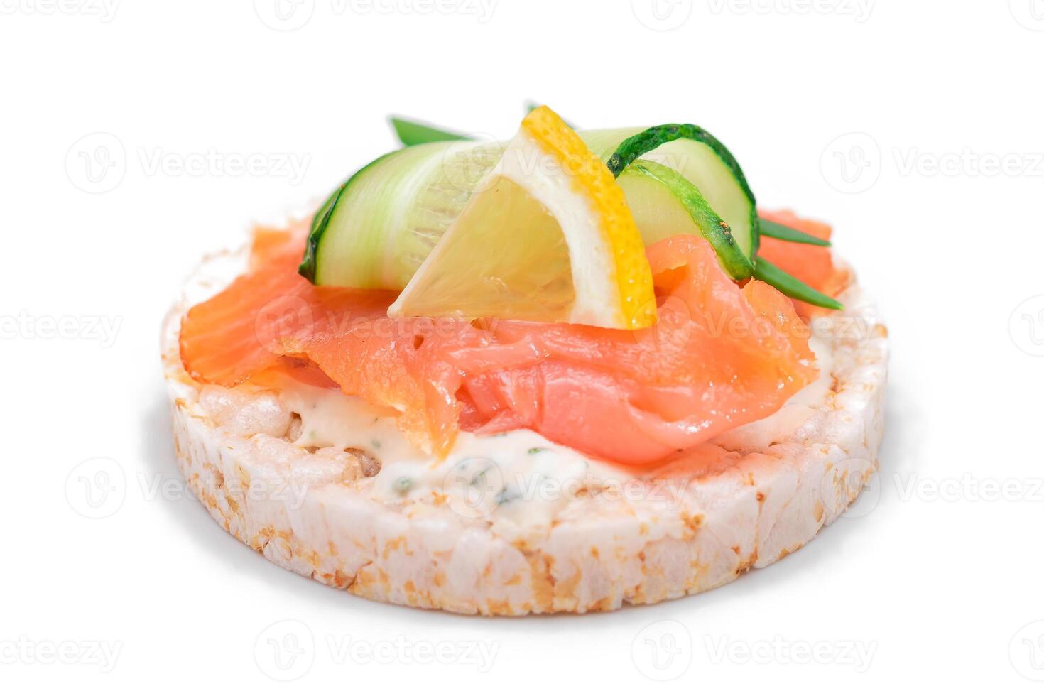Rice Cake Sandwich with Fresh Salmon, Cucumber, Lemon and Greens - Isolated on White Background. Diet Food. Quick and Healthy Sandwiches. Crispbread with Fresh Fillings. Healthy Dietary Snack photo