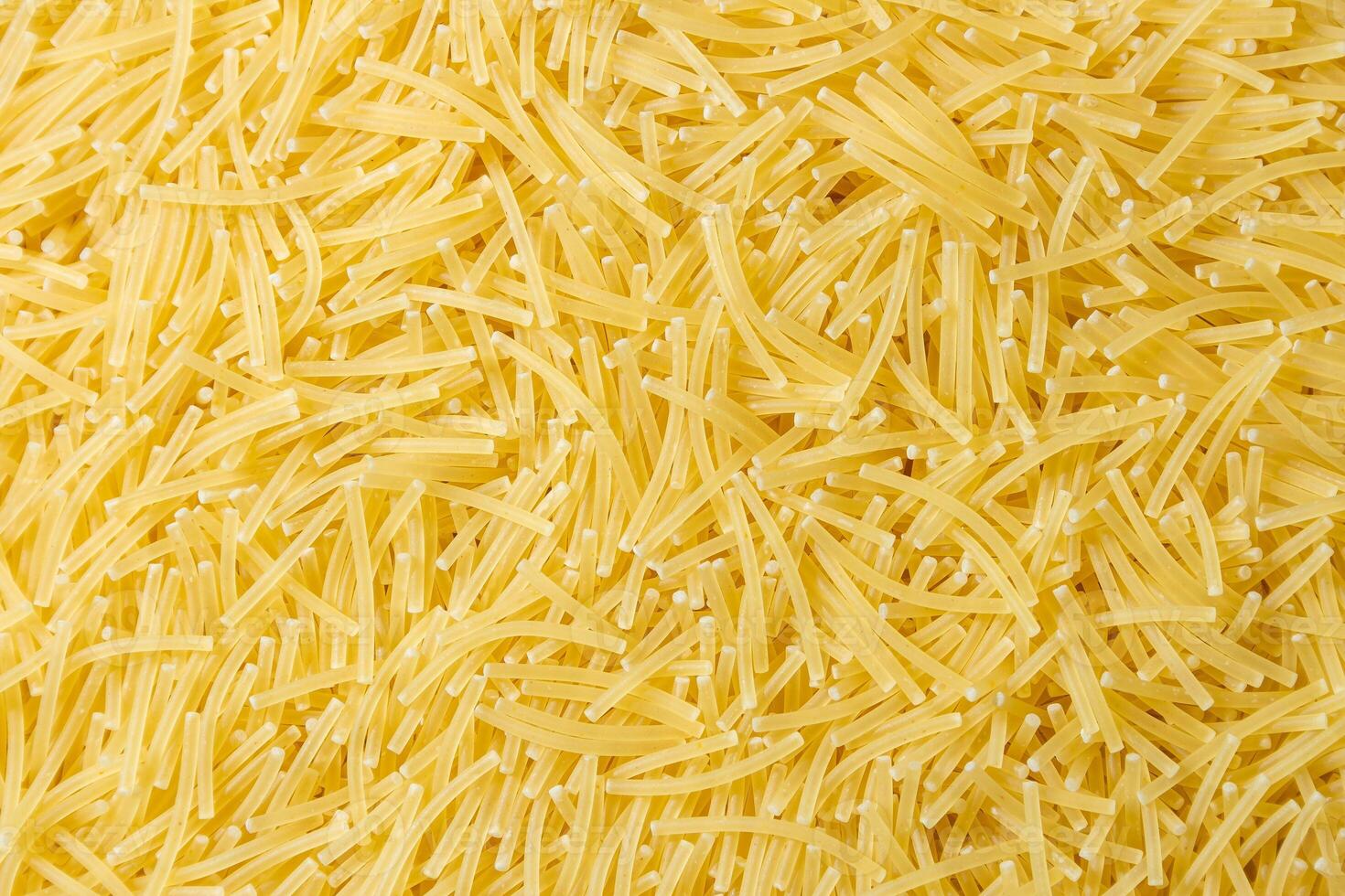 Uncooked Filini Pasta. A Culinary Canvas of Noodles, Creating a Lively and Textured Background for Gourmet Cooking. Dry Pasta. Raw Macaroni - Top View, Flat Lay photo