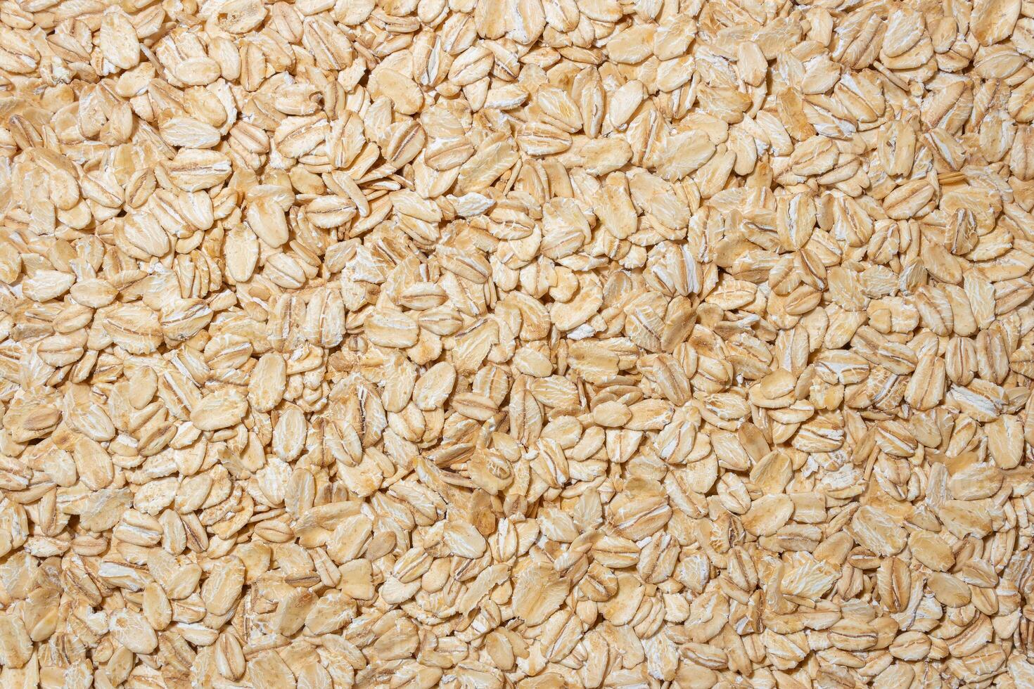 Uncooked Oat Flakes background - Top View, Flat Lay. Scattered Dry and Raw Oat Flakes. Healthy Breakfast and Diet Eating Ingredients photo