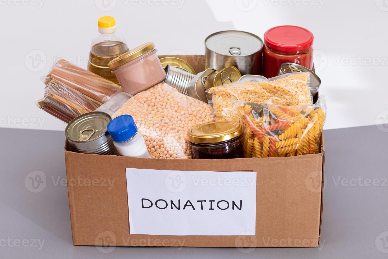 Donation Box of Free Food. Carton Box with Canned Food, Cereals and Grocery. Meal Reserves. Emergency Food Storage in Case of Crisis. Free Social Help, Blessings and Care. Strategic Food Supplies photo