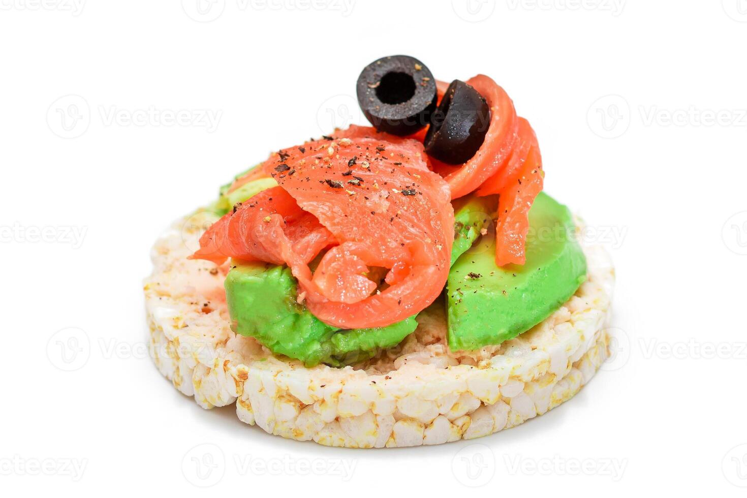 Rice Cake Sandwich with Fresh Salmon, Avocado and Olives - Isolated on White. Easy Breakfast. Diet Food. Quick and Healthy Sandwiches. Crispbread with Tasty Filling. Healthy Dietary Snack - Isolation photo