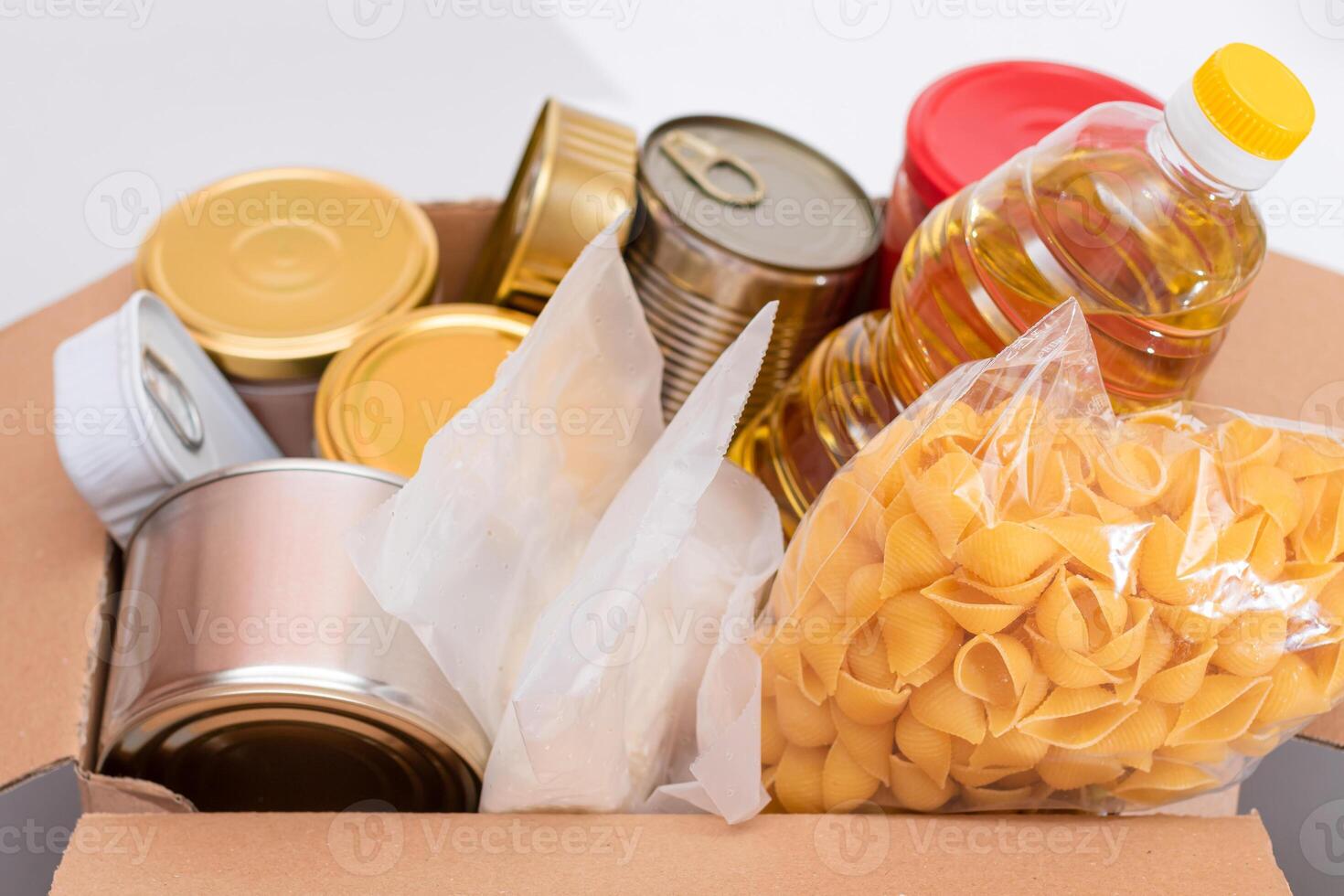Donation Box of Free Food. Carton Box with Canned Food, Cereals and Grocery. Meal Reserves. Emergency Food Storage in Case of Crisis. Free Social Help, Blessings and Care. Strategic Food Supplies photo
