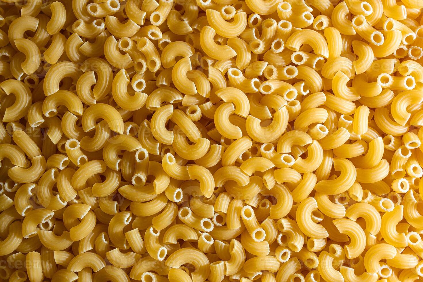 Uncooked Chifferi Rigati Pasta. A Culinary Canvas of Chifferi Rigati, Creating a Lively and Textured Background for Gourmet Cooking. Dry Pasta. Raw Macaroni - Top View, Flat Lay photo