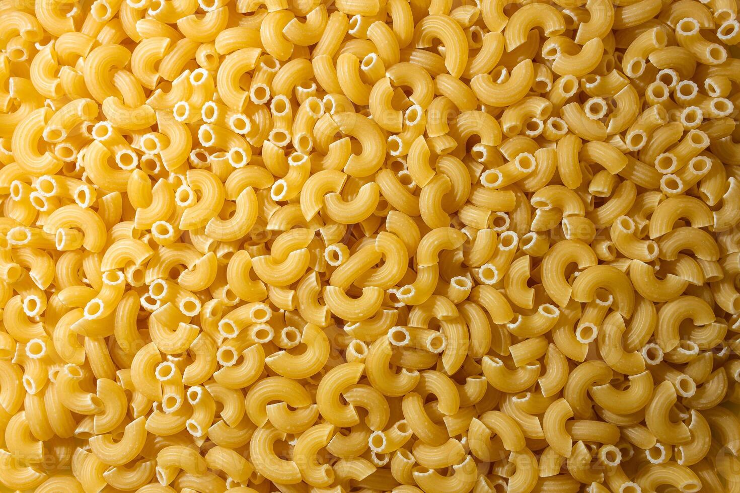 Uncooked Chifferi Rigati Pasta. A Culinary Canvas of Chifferi Rigati, Creating a Lively and Textured Background for Gourmet Cooking. Dry Pasta. Raw Macaroni - Top View, Flat Lay photo