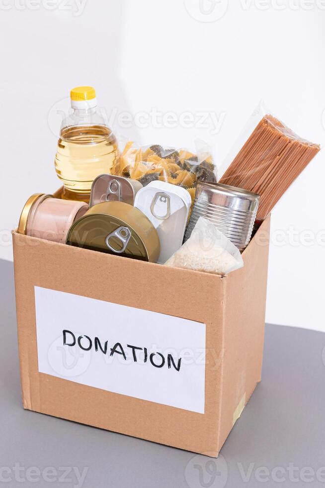 Donation Box of Free Food. Carton Box with Canned Food, Cereals and Grocery. Meal Reserves. Emergency Food Storage in Case of Crisis. Free Social Help, Blessings and Care. Strategic Food Supplies photo