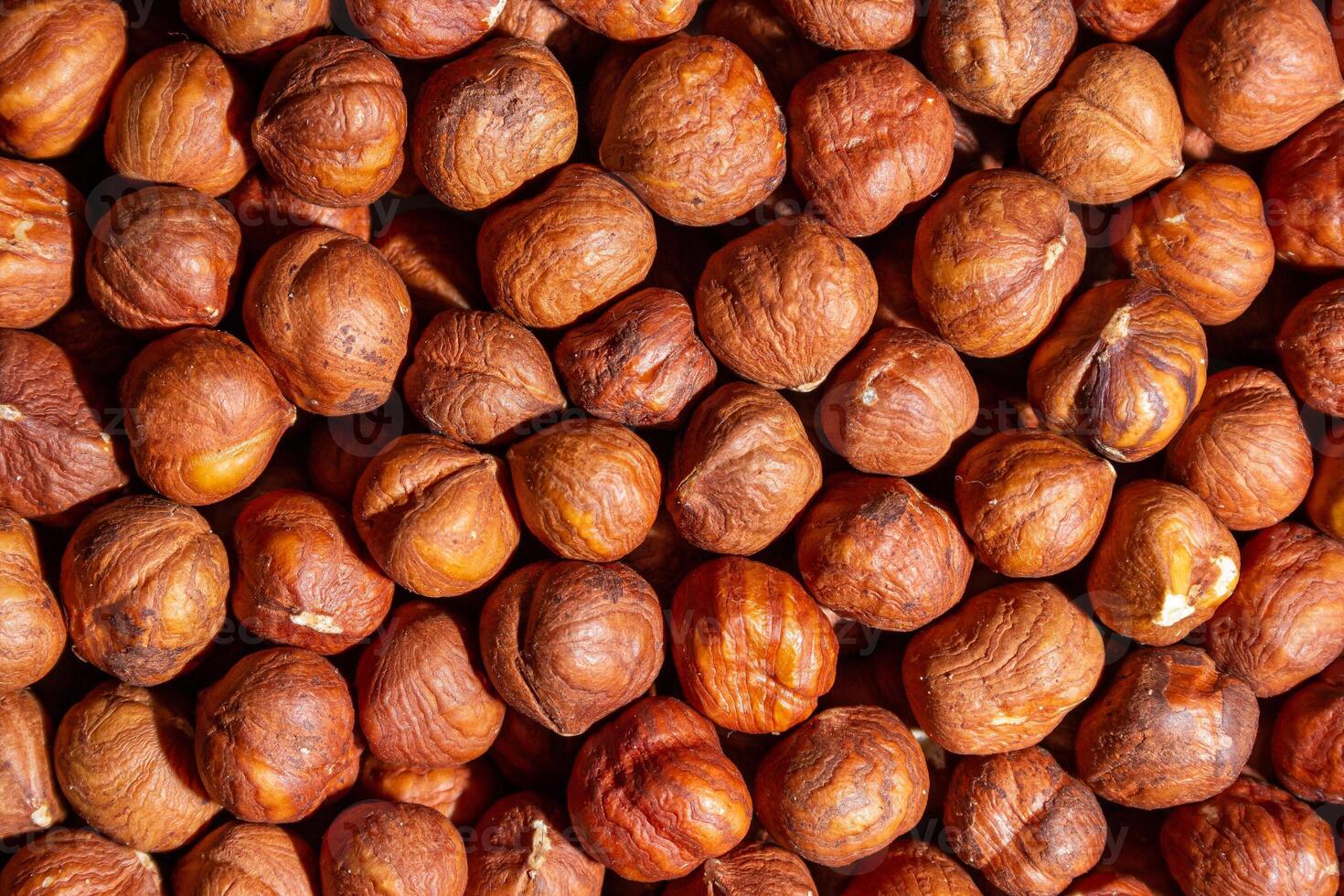 Scattered Peeled Hazelnut - Top View. Background from Hazelnuts. Natural High-Calorie Snacks photo