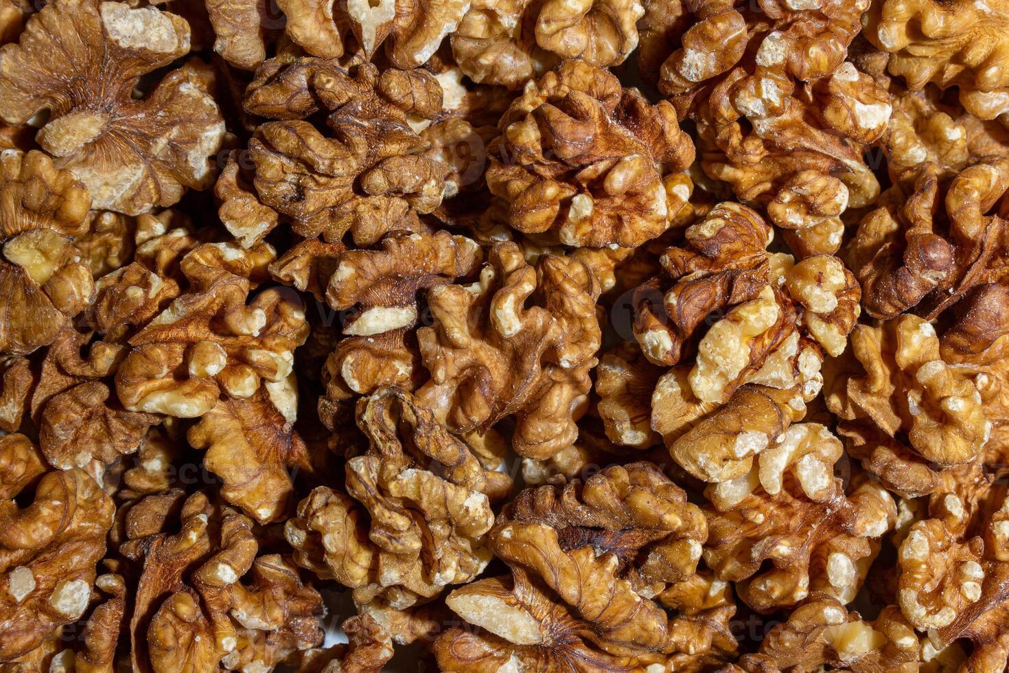 Scattered Shelled Walnuts. Background from Walnut. Natural High-Calorie Snacks photo