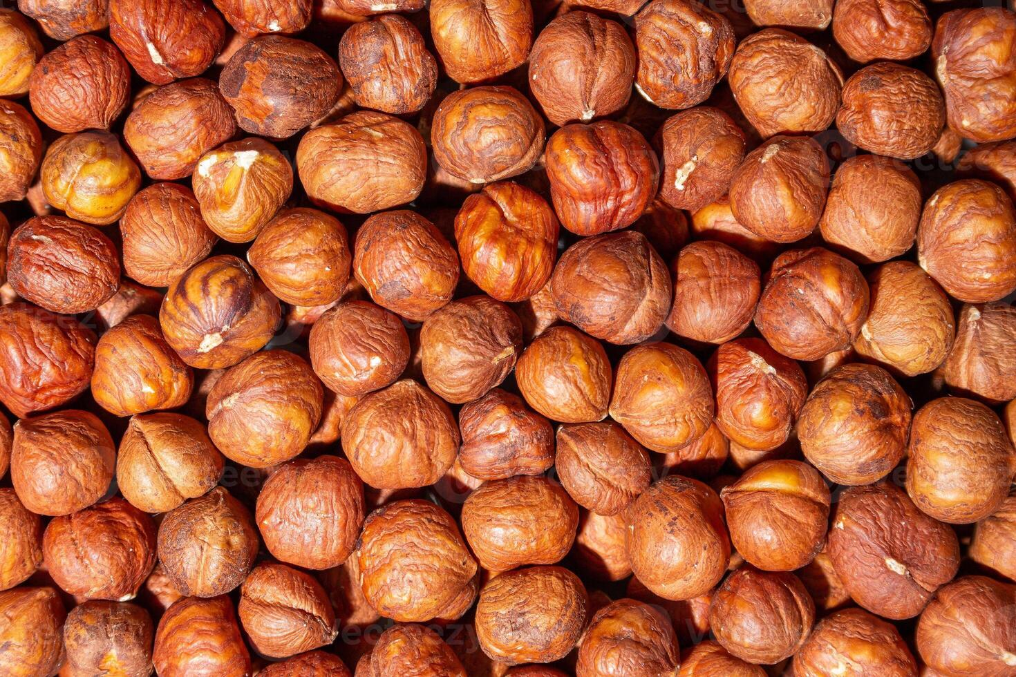 Scattered Peeled Hazelnut - Top View. Background from Hazelnuts. Natural High-Calorie Snacks photo