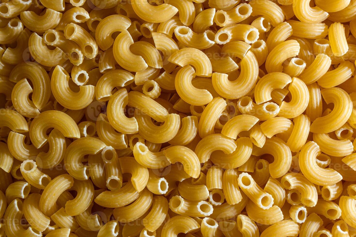 Uncooked Chifferi Rigati Pasta. A Culinary Canvas of Chifferi Rigati, Creating a Lively and Textured Background for Gourmet Cooking. Dry Pasta. Raw Macaroni - Top View, Flat Lay photo