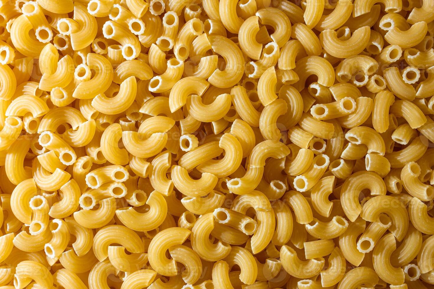 Uncooked Chifferi Rigati Pasta. A Culinary Canvas of Chifferi Rigati, Creating a Lively and Textured Background for Gourmet Cooking. Dry Pasta. Raw Macaroni - Top View, Flat Lay photo