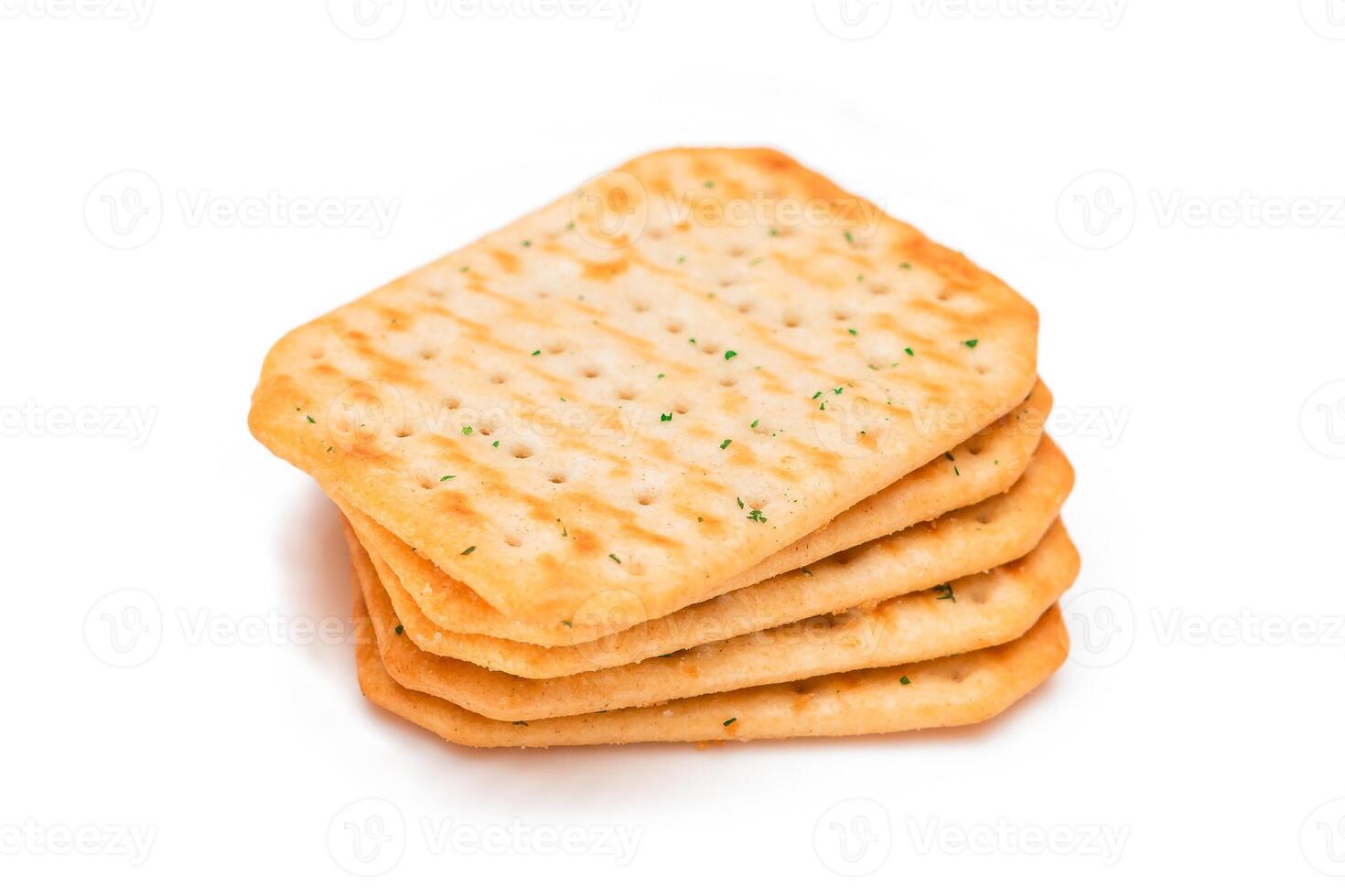 Stack of Crispy Salted Crackers with Greens - Isolated on White. Easy Snack - Isolation photo